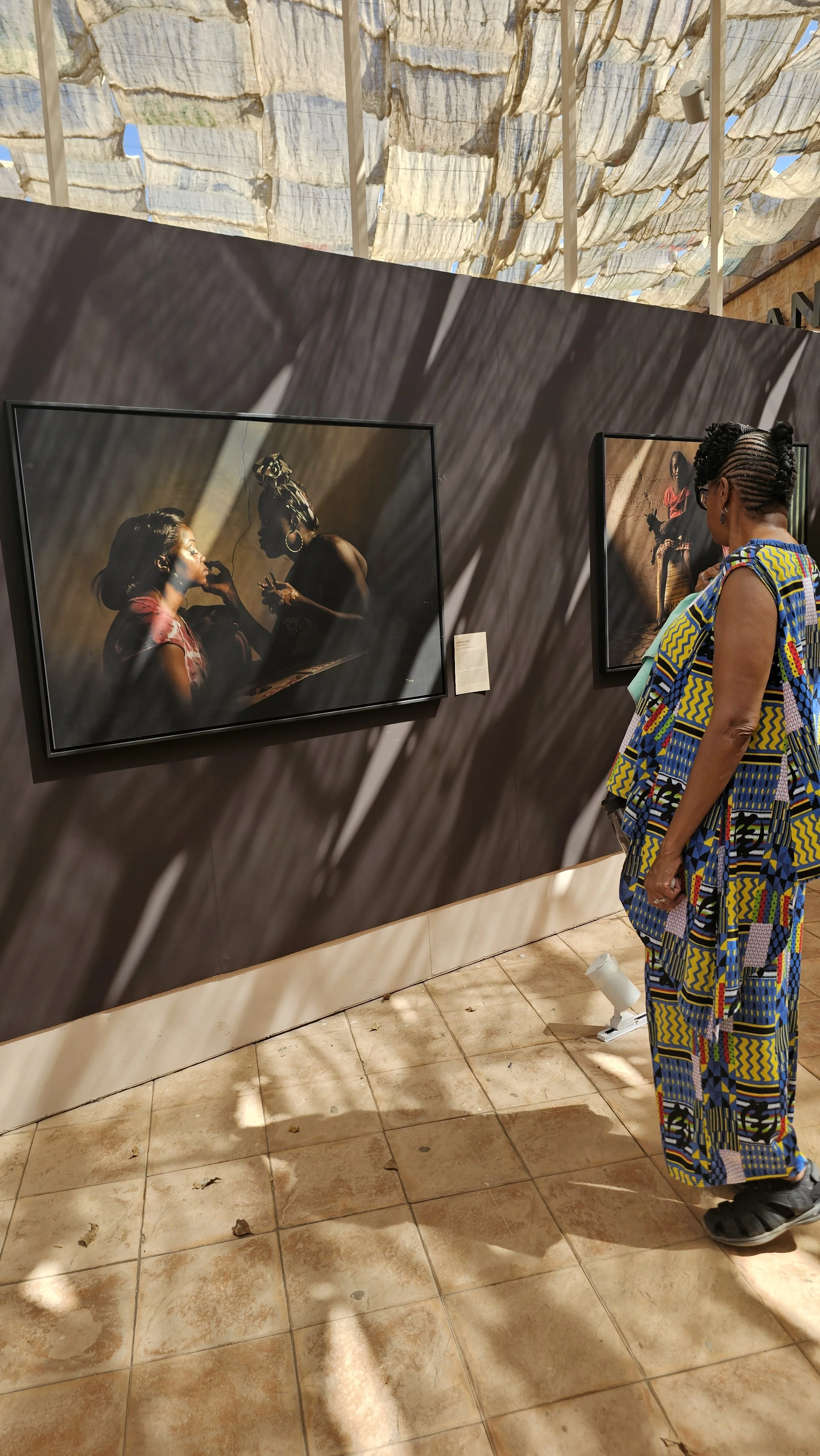 Tour member quietly viewing artwork outside of the Renaissance Monument in Dakar.