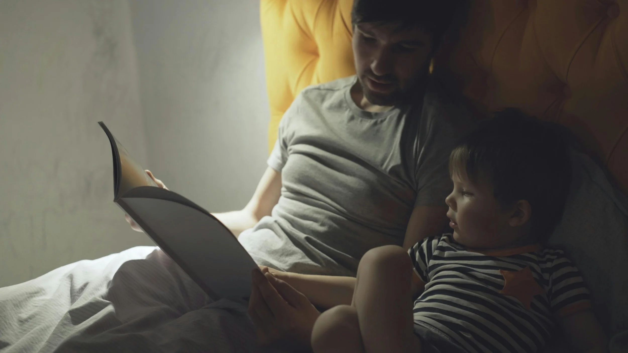 Parent reading a picture book to a five-year-old while explaining worry, fear, and brave first steps
