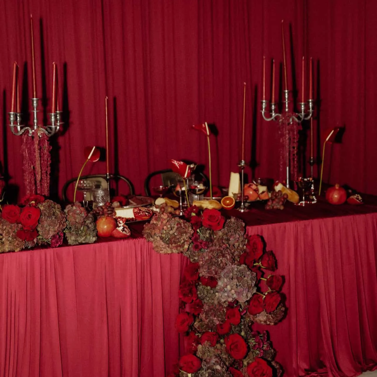 A color-drenched maroon/burgundy sweetheart's table with food styling at The Fifth Floor in Ogden, UT