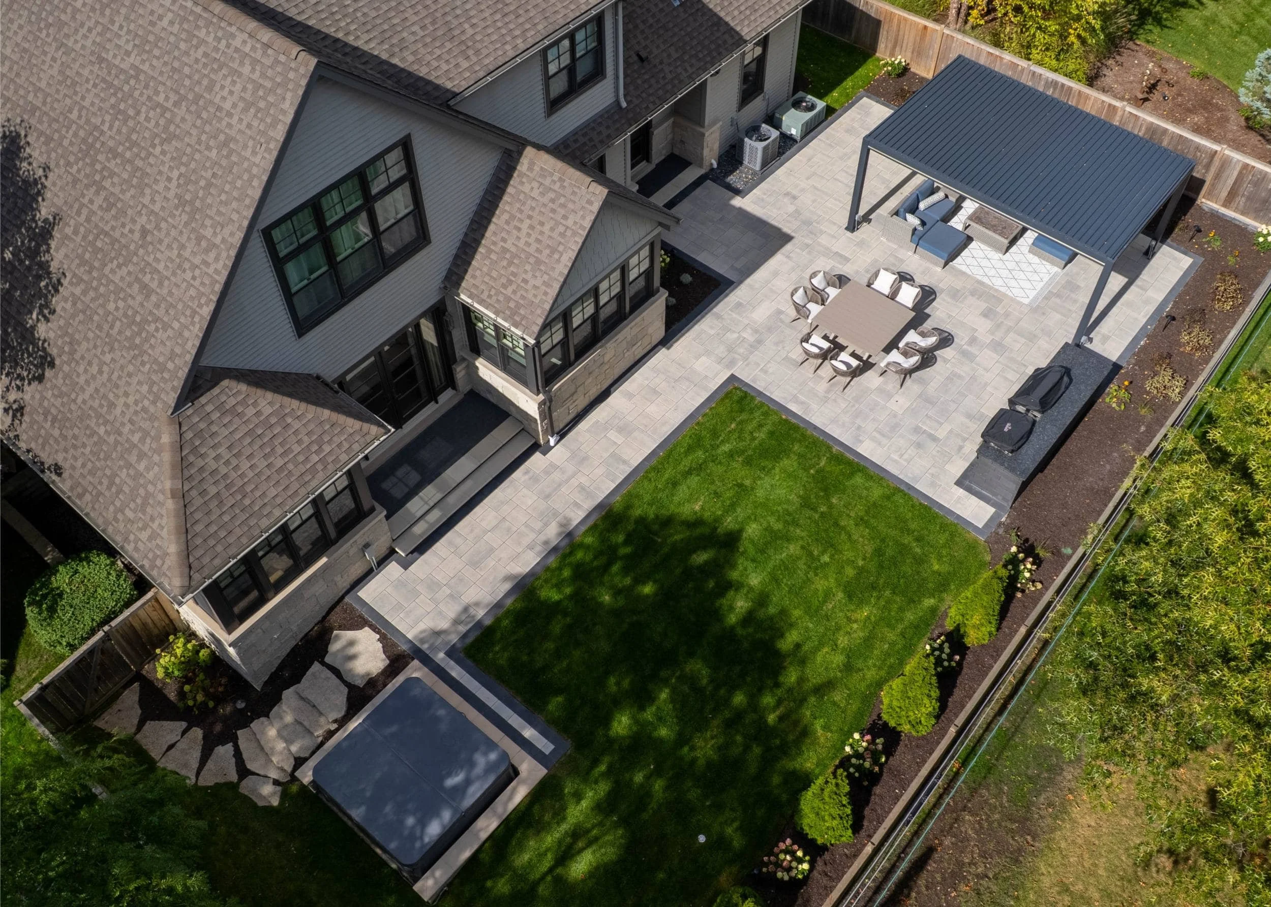 A contemporary fire pit centerpiece in a landscaped backyard in Wheaton, IL