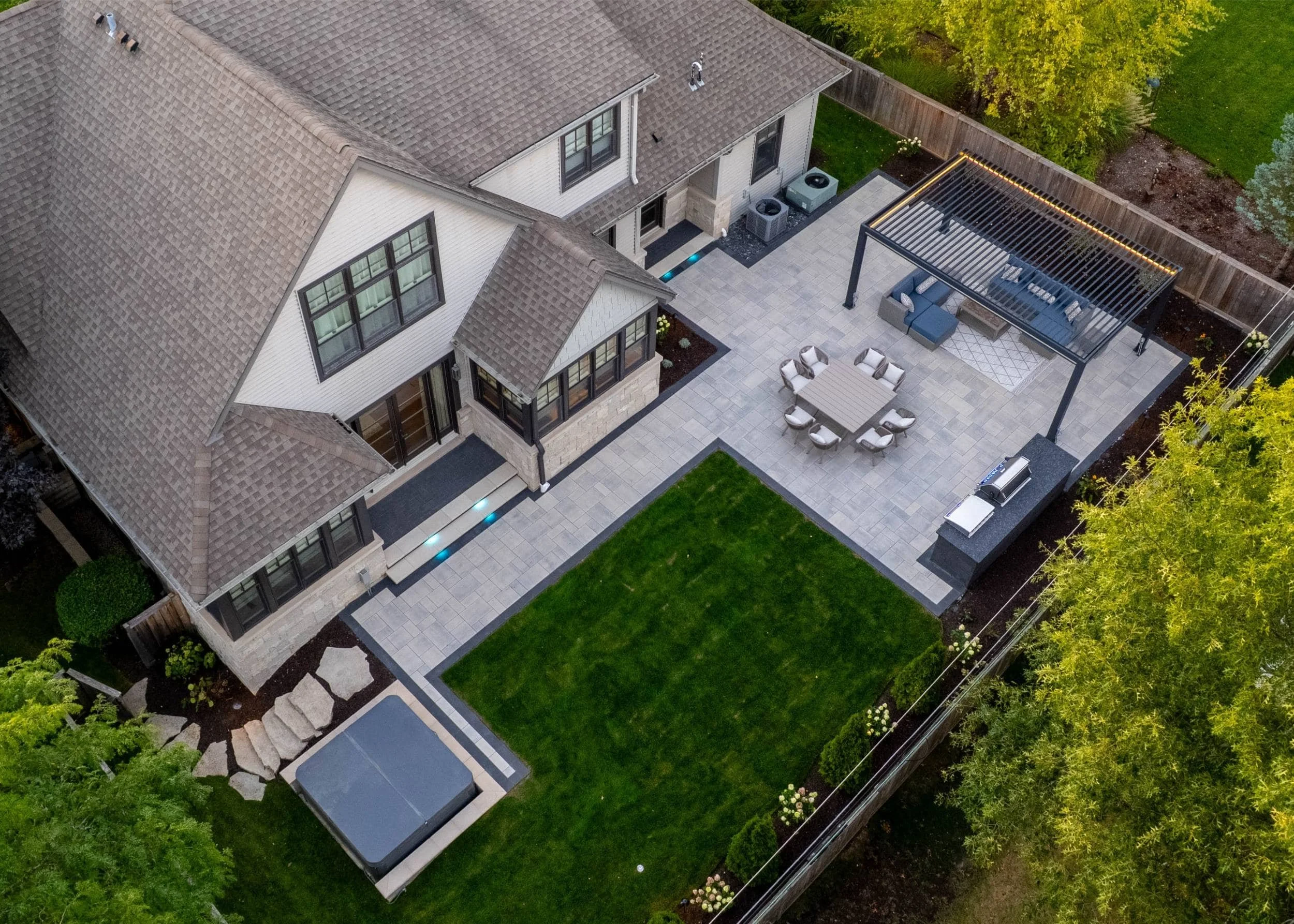 A modern backyard retreat featuring landscape design and paver patio in Wheaton, IL