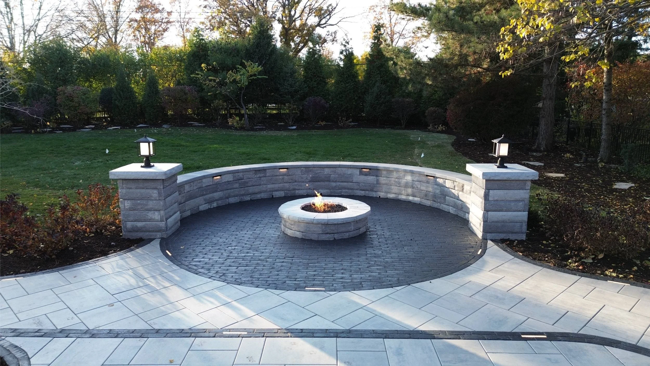 A beautiful backyard featuring a custom fire pit for cozy outdoor gatherings in Wheaton, IL
