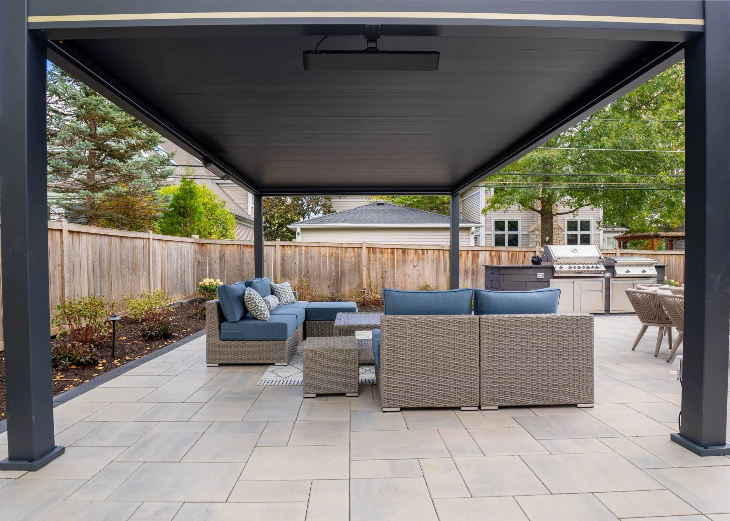 A clean-lined backyard design framed with privacy landscaping in Barrington Hills, IL