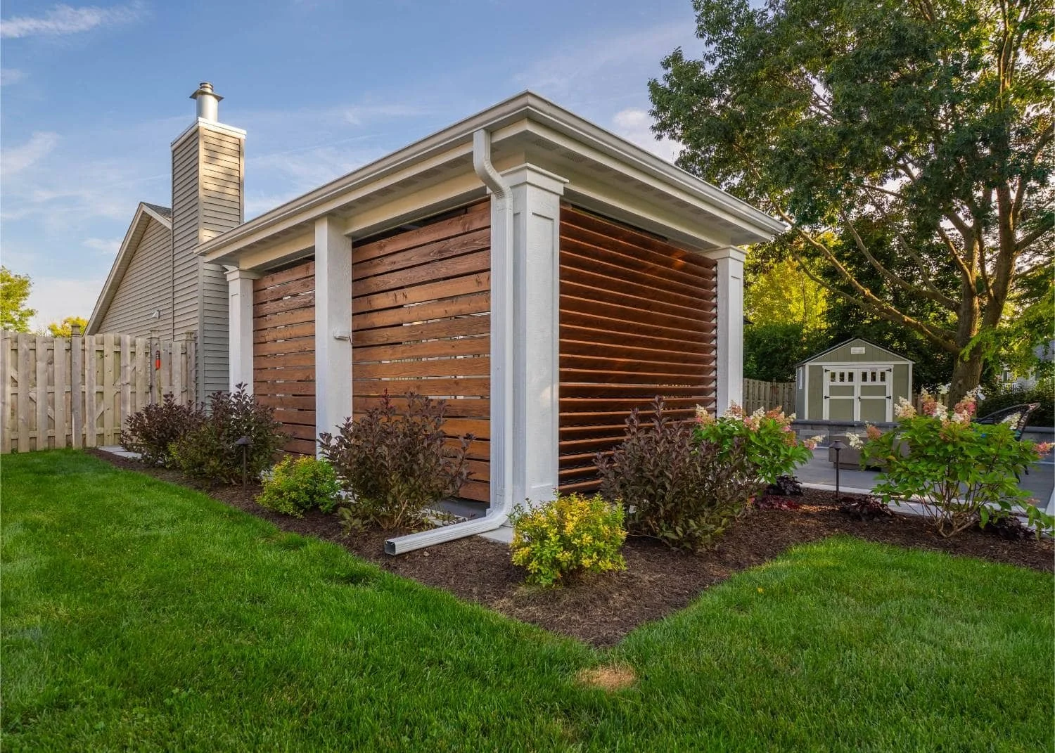 Detailed paver walkway and lush plantings surrounding outdoor seating area in Plainfield, IL