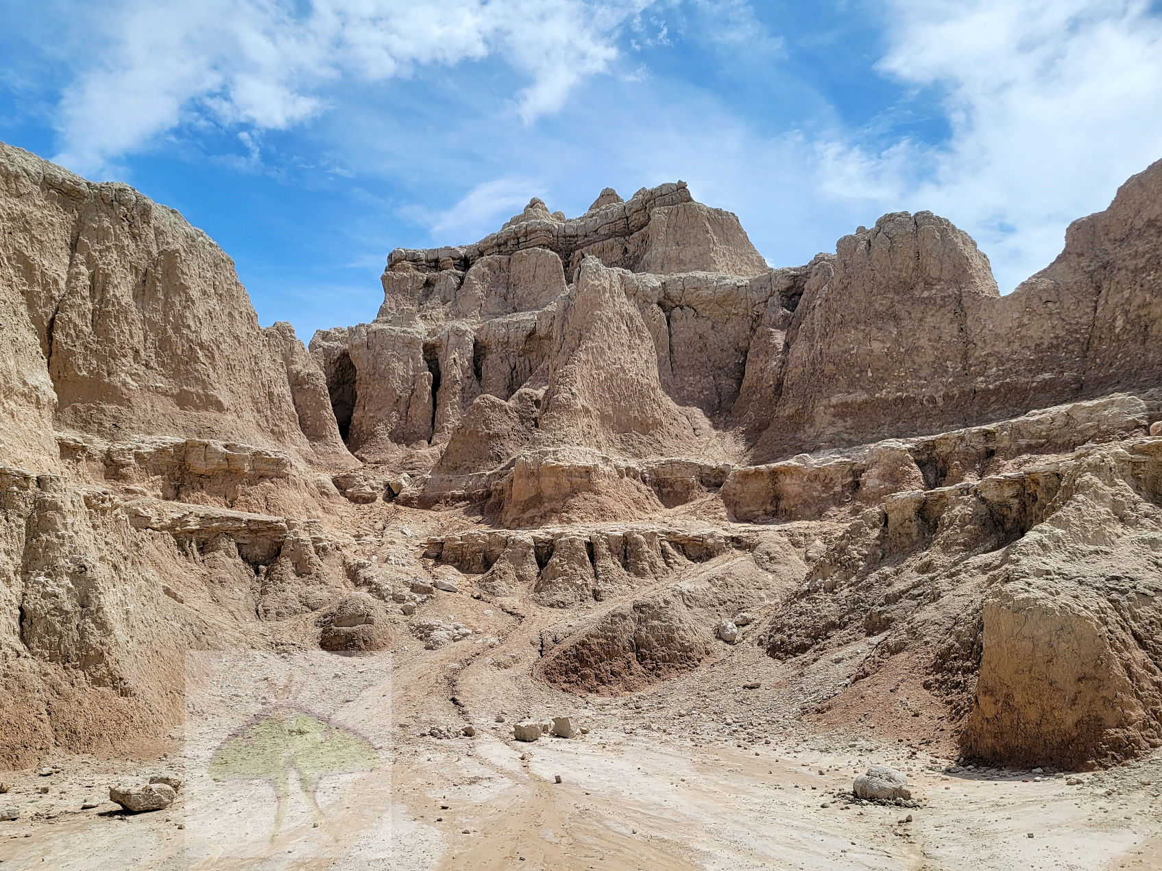 Badlands Formation-Endless winds and rains have masterfully chiseled this pale red ridge into one of the Badlands' most striking formations. Against a backdrop of sweeping clouds and blue sky, this area struck me as the most breathtaking and photogen