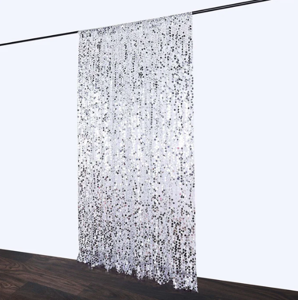 Silver sequin curtain hanging from rod
