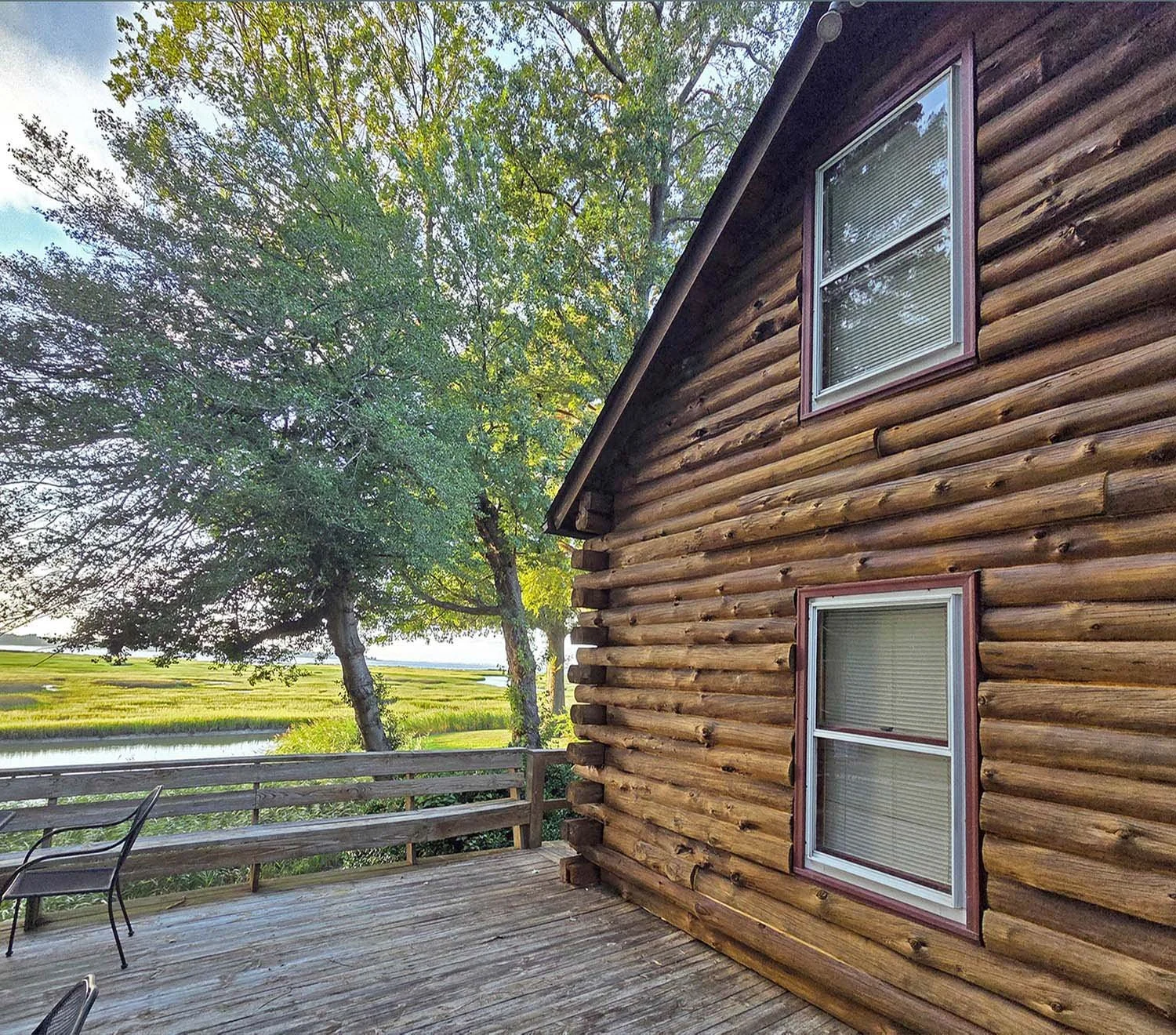 Situated on family land right on the Nansemond River, this cabin offers peace, freedom, and stunning views of the marsh and waters beyond. All it *was* lacking was log protection and sealant to last into future generations. 