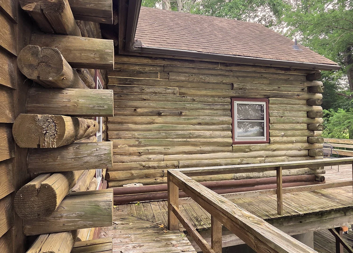 Weathered and showing signs of mildew and fungus, this river home had never before been stained.