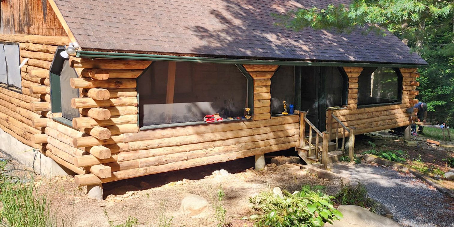 We replaced the original porch siding vignettes with hand hewn logs to match, cutting logs down to siding on-site. They blended in perfectly.