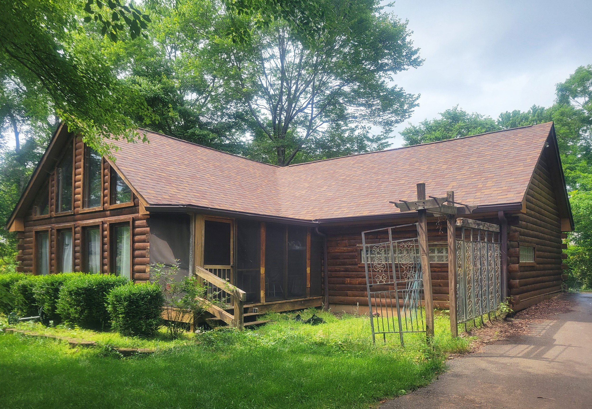 Neglected and overgrown, the finish on this log cabin hadn't been attended to in many years.