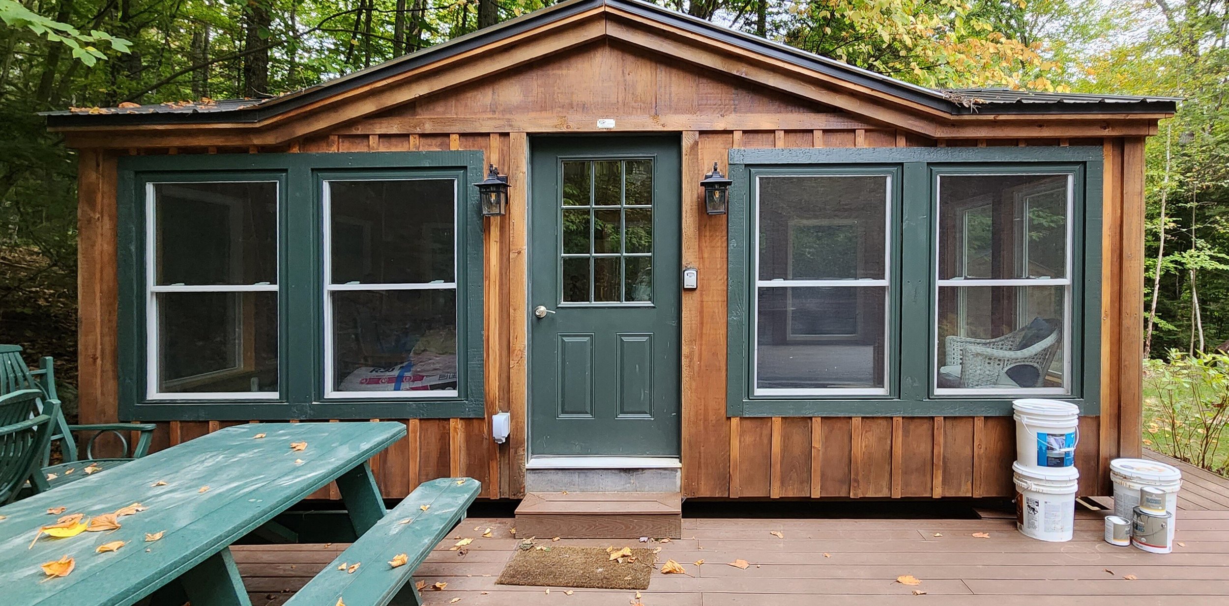 We cleaned and stained three outbuildings to match, as well, including this sleeping cabin, a utility shed, and a firewood shelter.