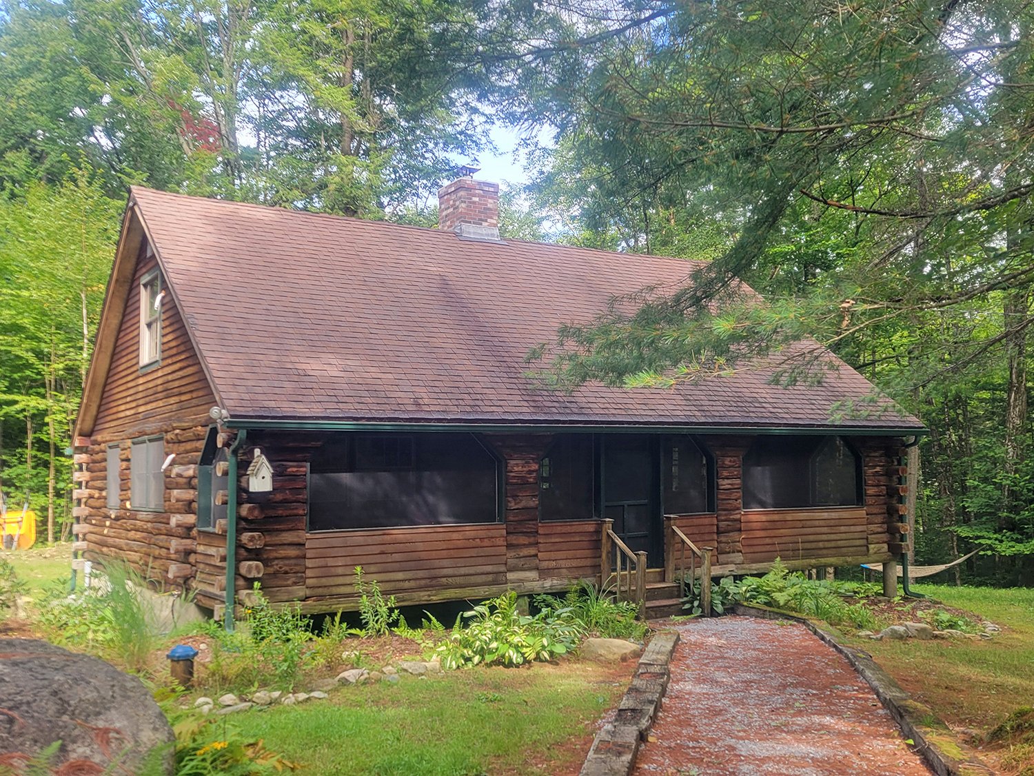 Mismatched gable ends, quirky porch siding, dried out logs, rot repair...this 50-year-old vacation cabin got a much-needed facelift.