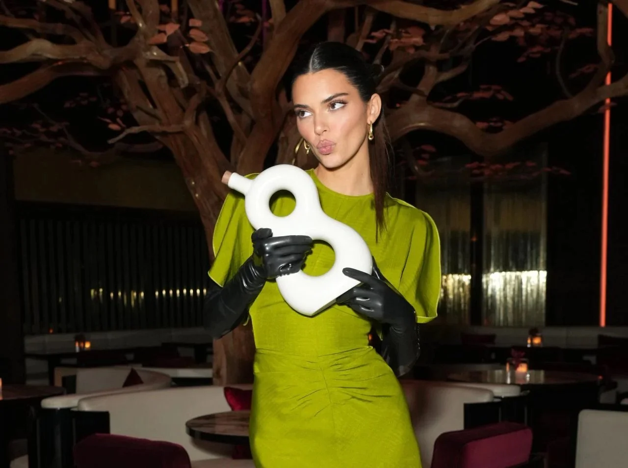 Kendall Jenner holding 818 Tequila bottle at event activation