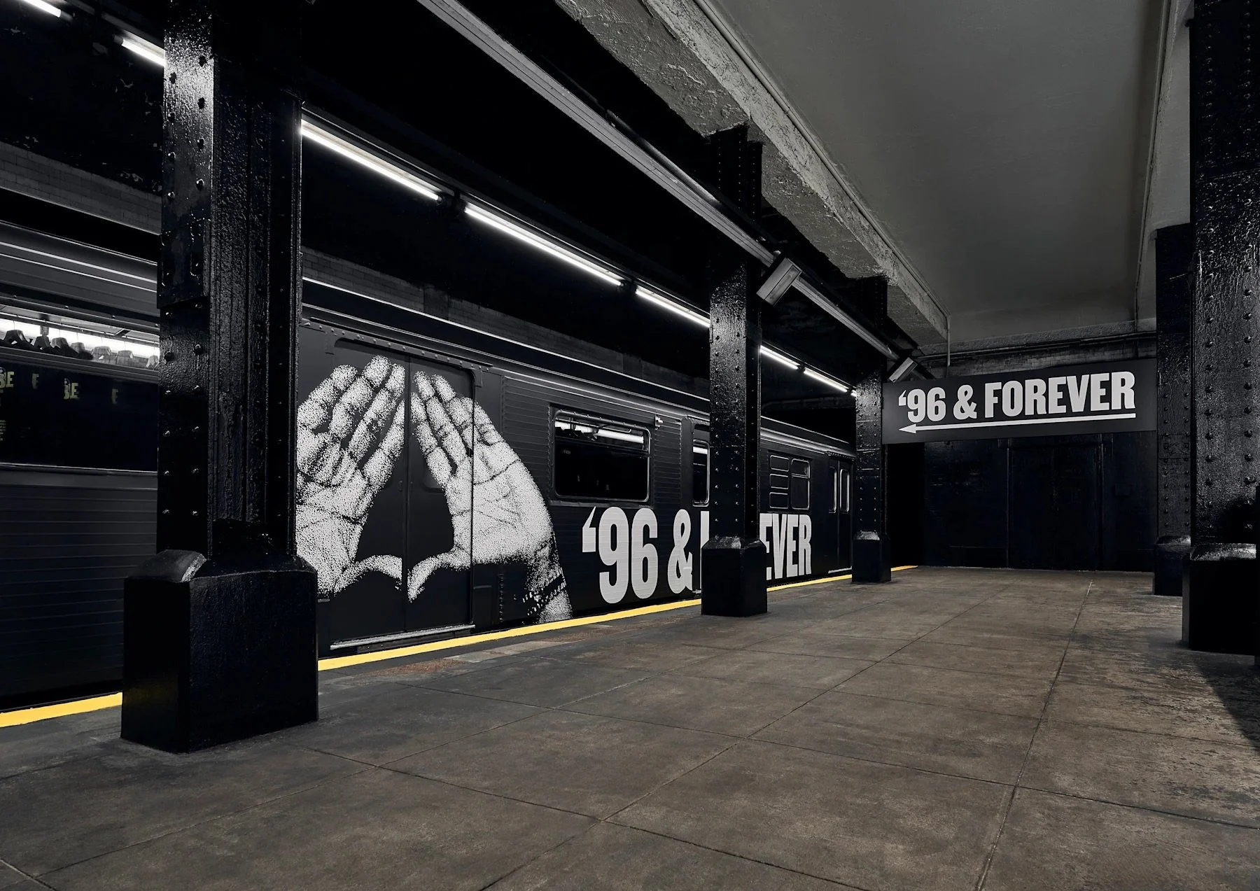 Underground subway platform with a black wall featuring a large graffiti-style image of two hands forming a triangle shape, with the text ' '96 & FOREVER' displayed on the wall. The scene is dimly lit with industrial style lighting fixtures.
