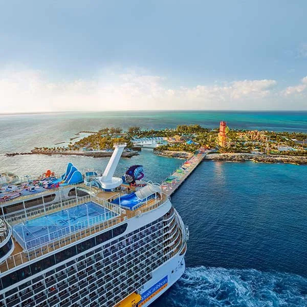 Cruise ship docked at a tropical island with water park