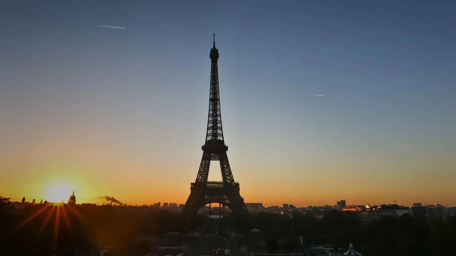 Eiffel Tower at sunset. 9 day Paris to Paris excursion with historic monuments, gardens, castles and French cuisine.