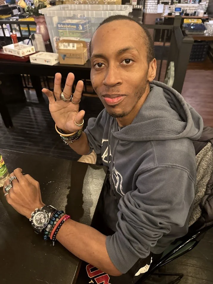 Josh, a local vegan, waving into the camera at our Vegan Game Night.jpg