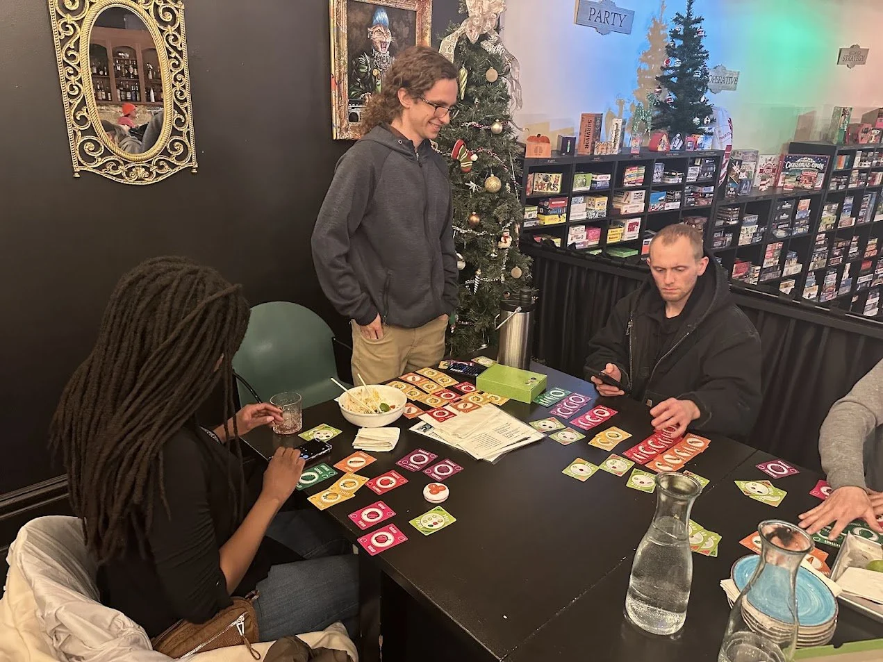 Gabe Luzynski, Craig, and Christiona playing Point Salad at our Vegan Game Night and St. Louis Veganuary campaign meeting at Pieces Board Game Bar and Cafe in Soulard.jpg