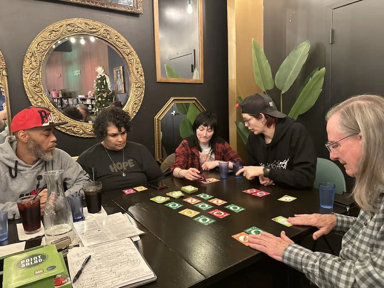 People strategizing while playing Point Salad at our Vegan Game Night at Pieces Board Game Bar and Cafe in the Soulard neighborhood of St. Louis.jpg