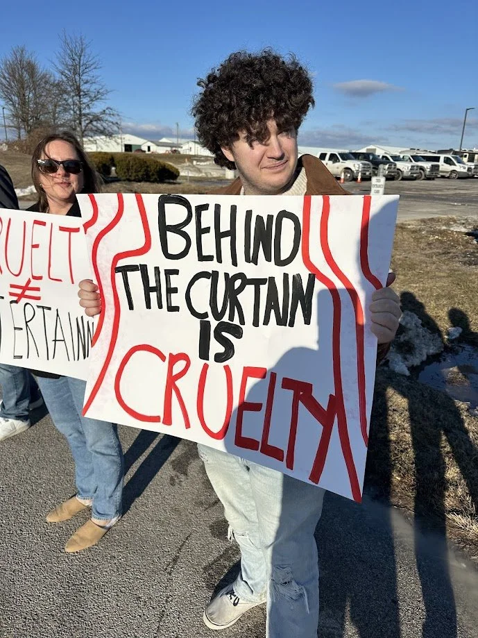 Andy holding a sign protesting circus cruelty.jpg