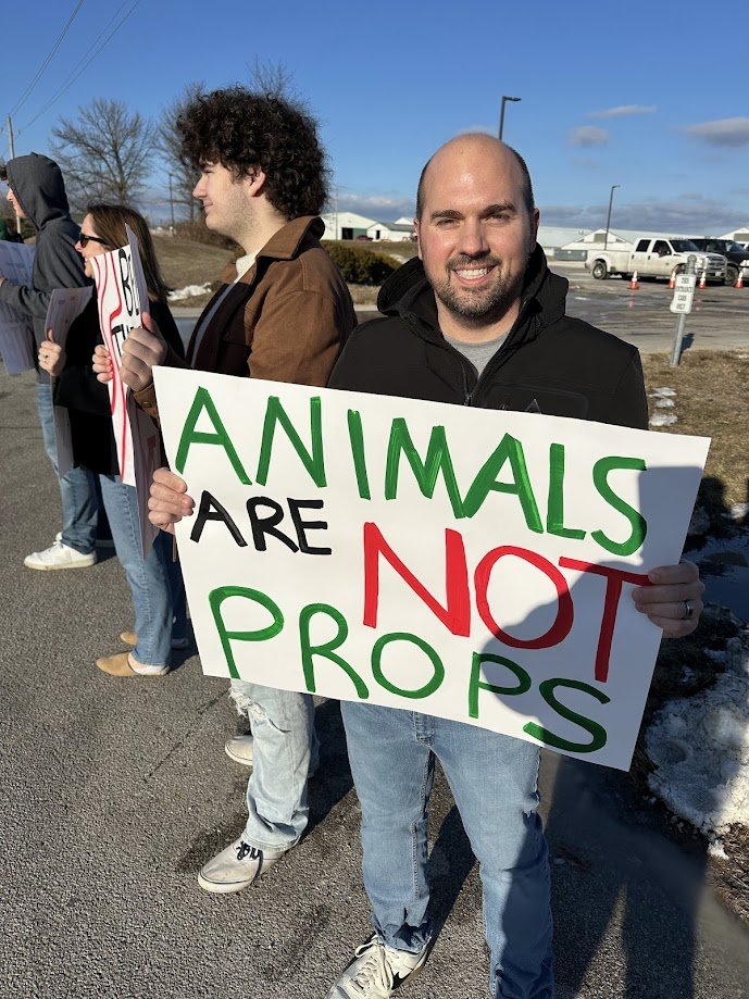 Dan holding a sign that says animals are not props.jpg
