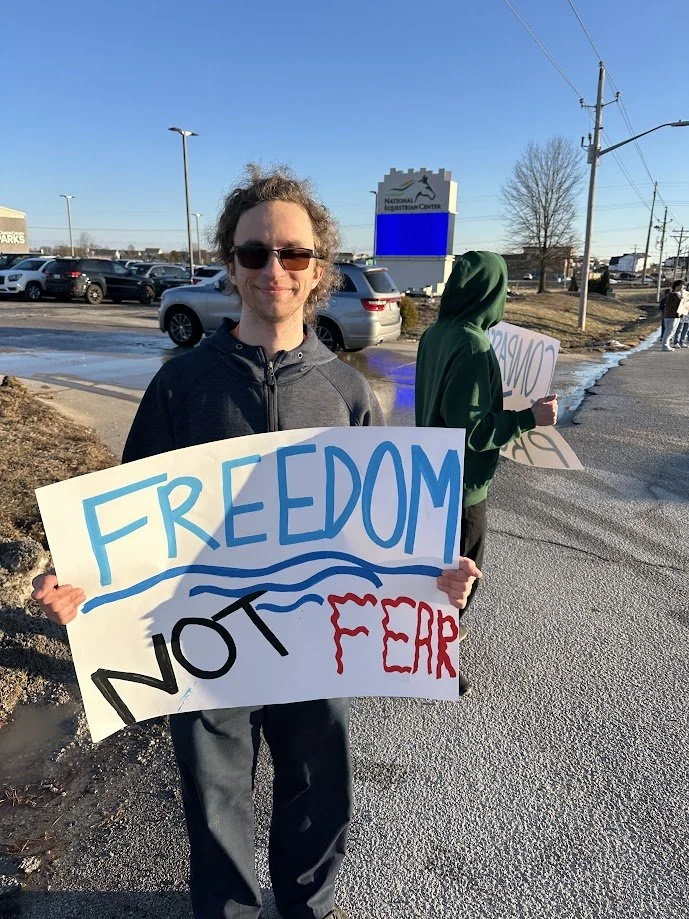 Gabe holding his freedom not fear poster.jpg
