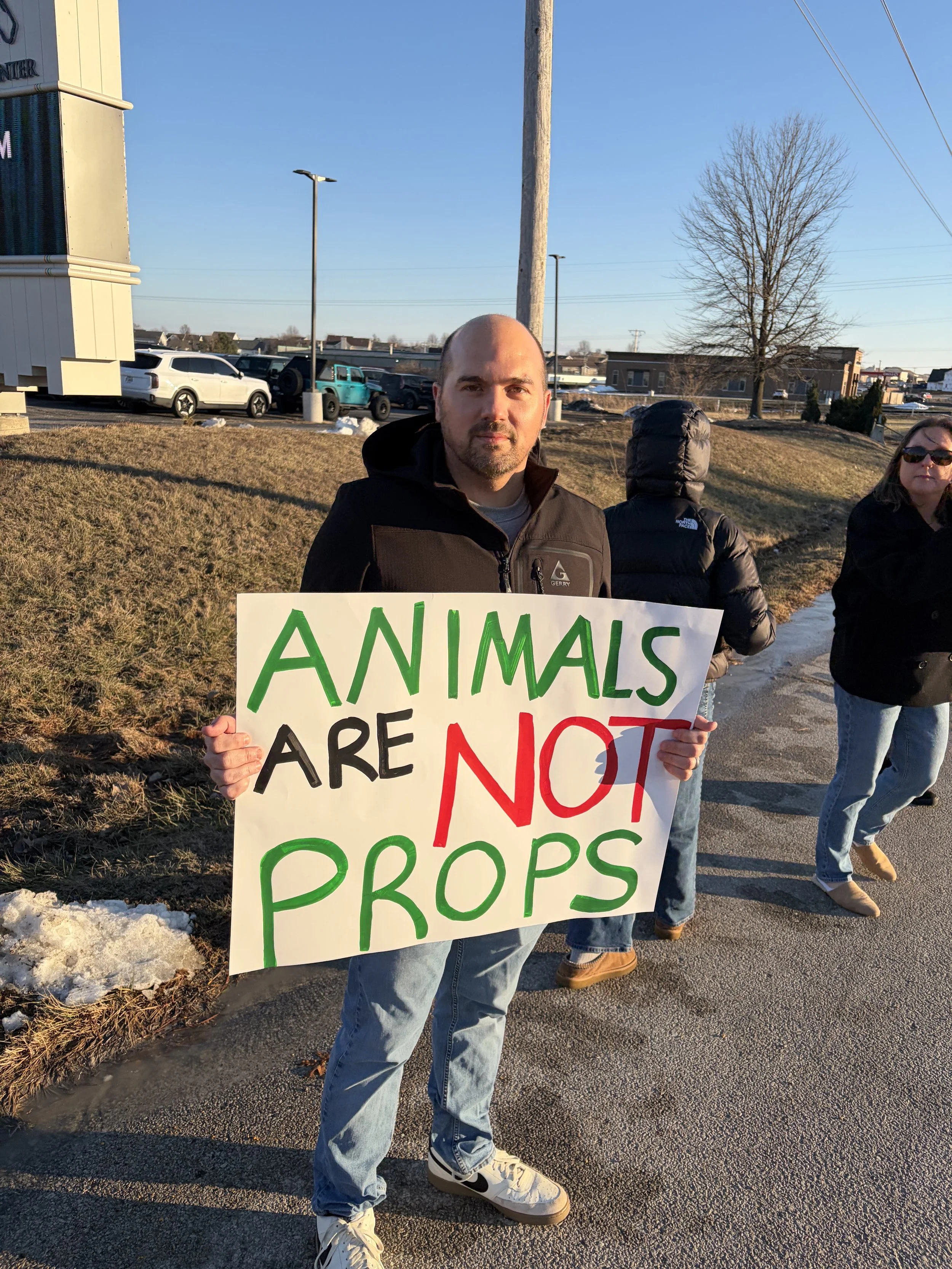 Dan holding a sign declaring that animals are not props at our circus protest in Lake St. Louis.jpeg