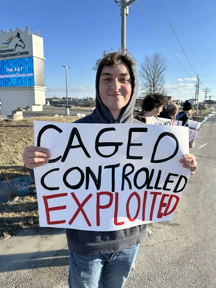 Troy holding a sign protesting the circus.jpg