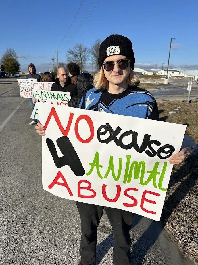 Vanya holding a sign at our circus protest.jpg