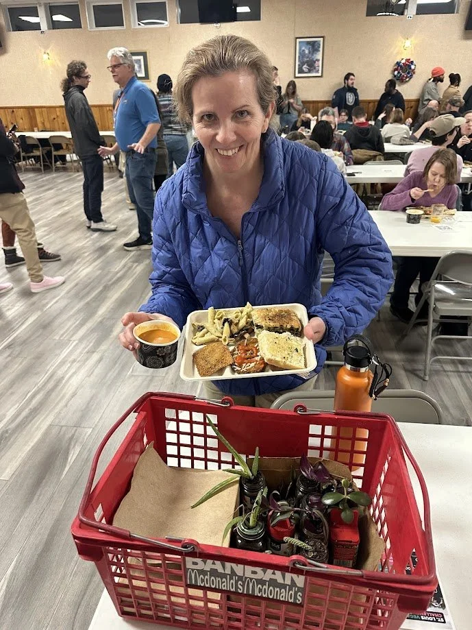 Jenna Luzynski looking at a box of plants at our Plant Italia Dinner at American Legion Post 111 in Shrewsbury, Missouri.jpg