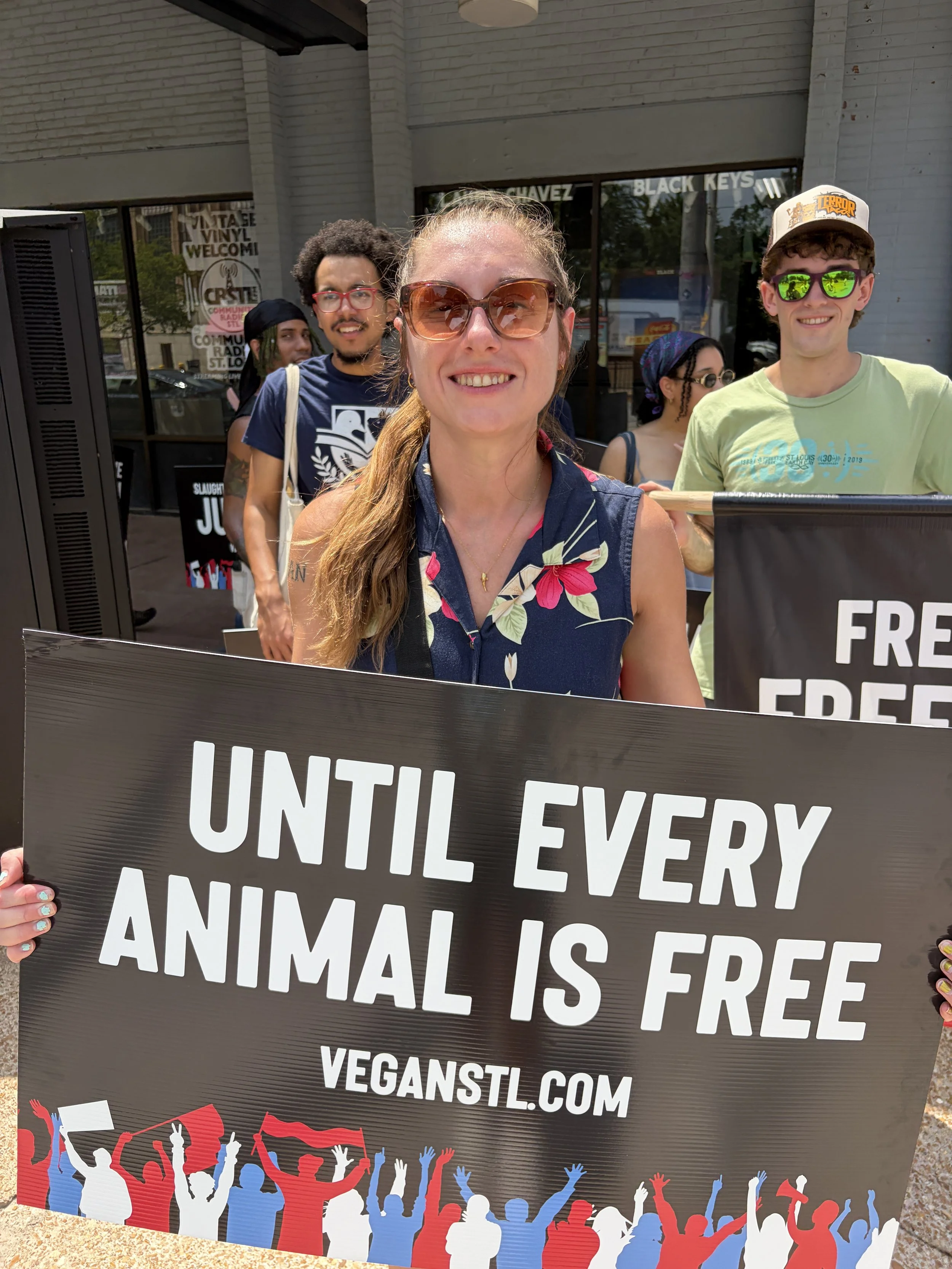 Vic holding a sign that declares no one is free until all are free at our Animal Freedom March