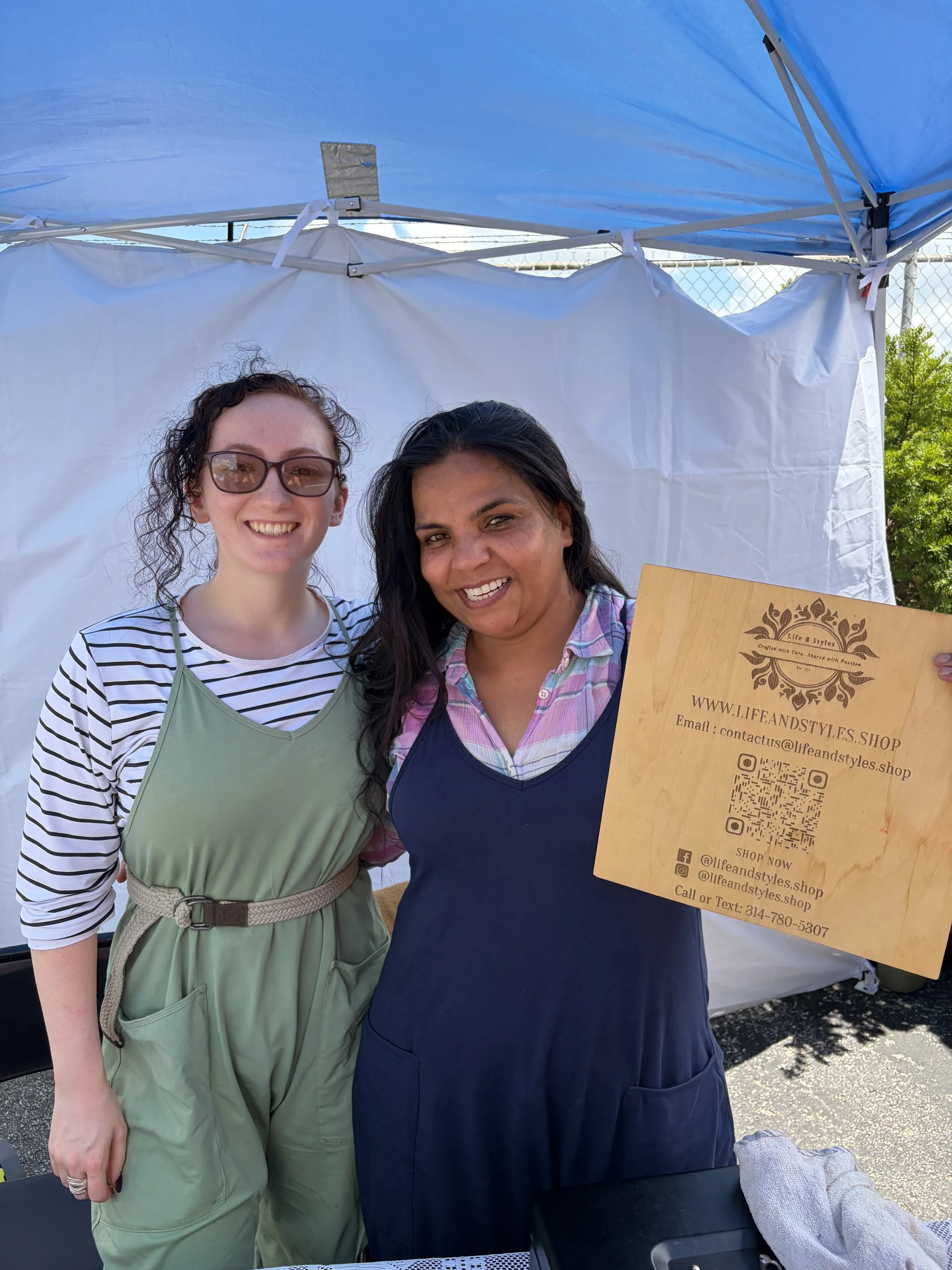 Priyaah of Life and Styles holds up her business logo at the Vegan Block Party at Bougie Bites in St. Louis, Missouri.jpg