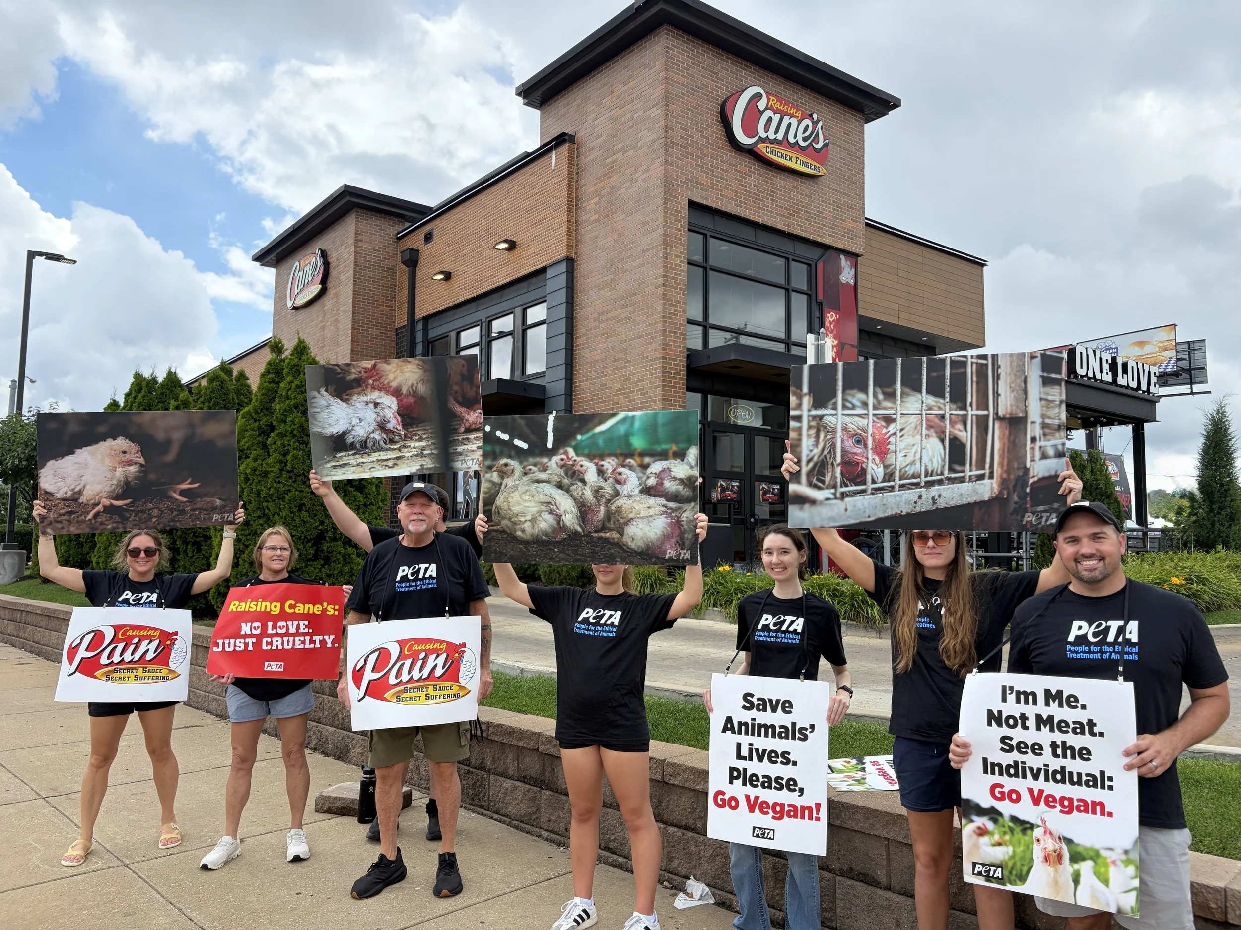 A group of activists pose for a photo outside of Raising Cane_s in St. Louis, Missouri.jpg