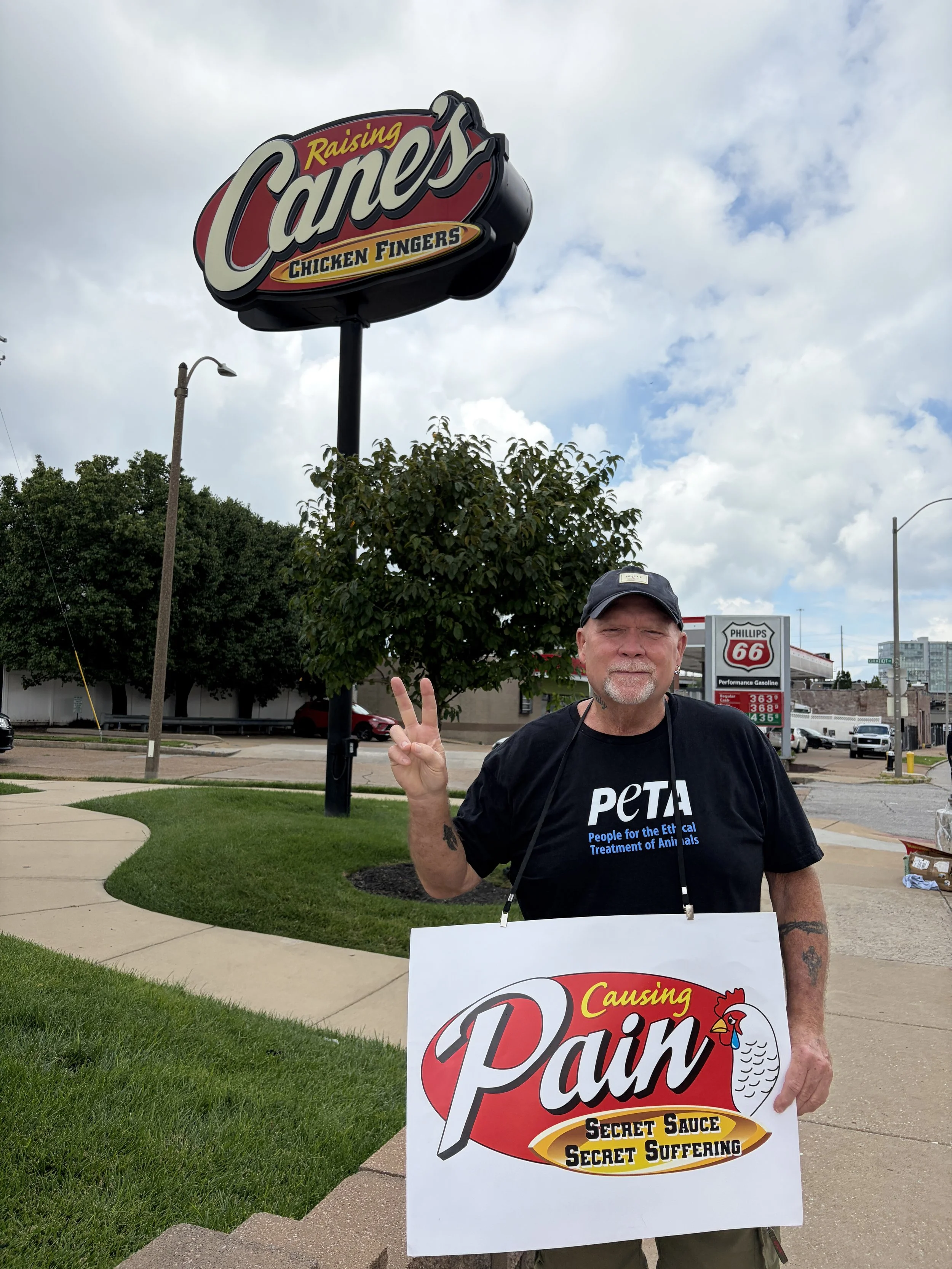 Ron holds up a peace sign as he protests Raising Cane_s in St. Louis, Missouri.jpg