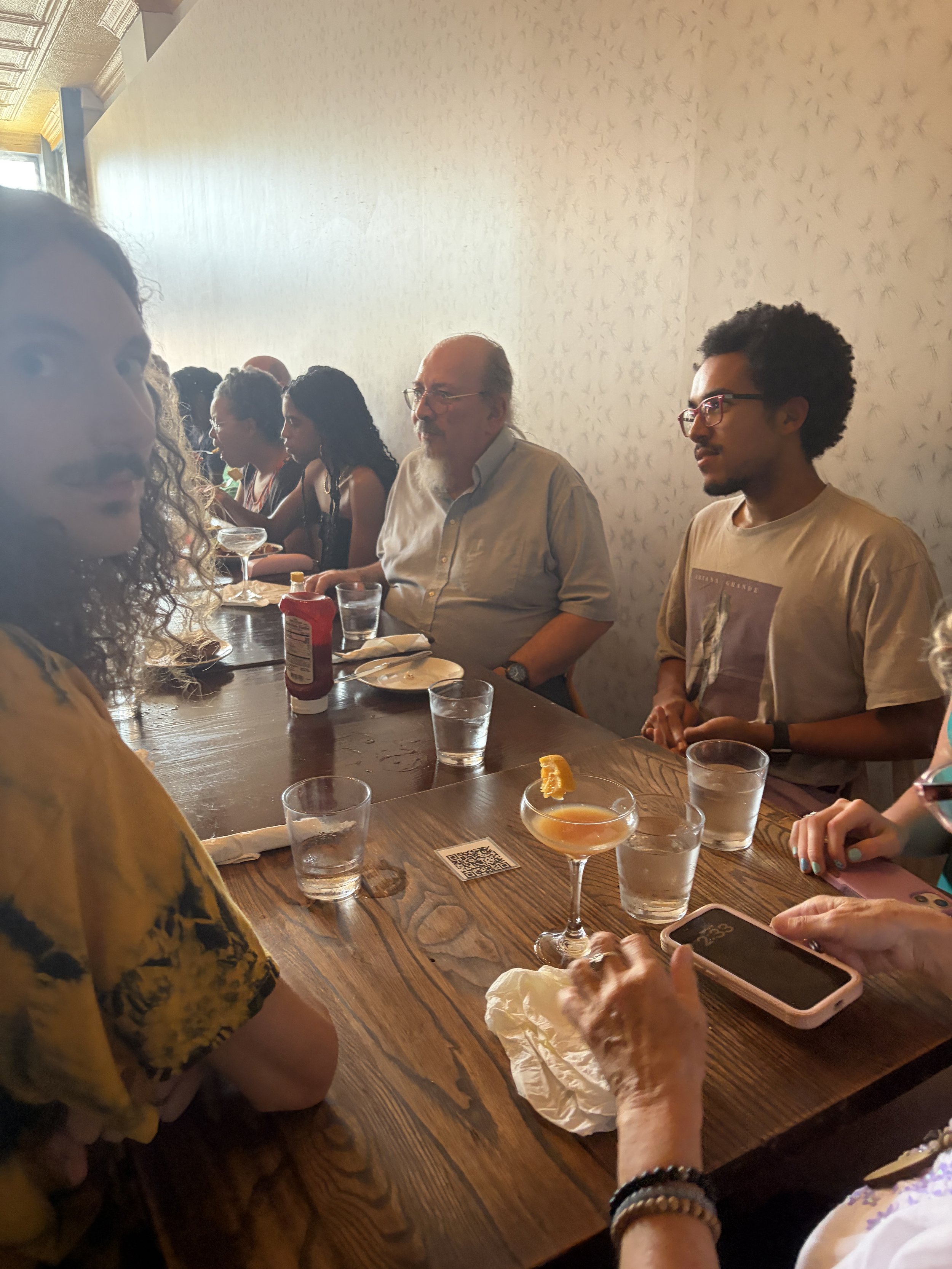 Group of activists talk amongst themselves at Vegan Brunch @ Tree House in St. Louis, Missouri.png