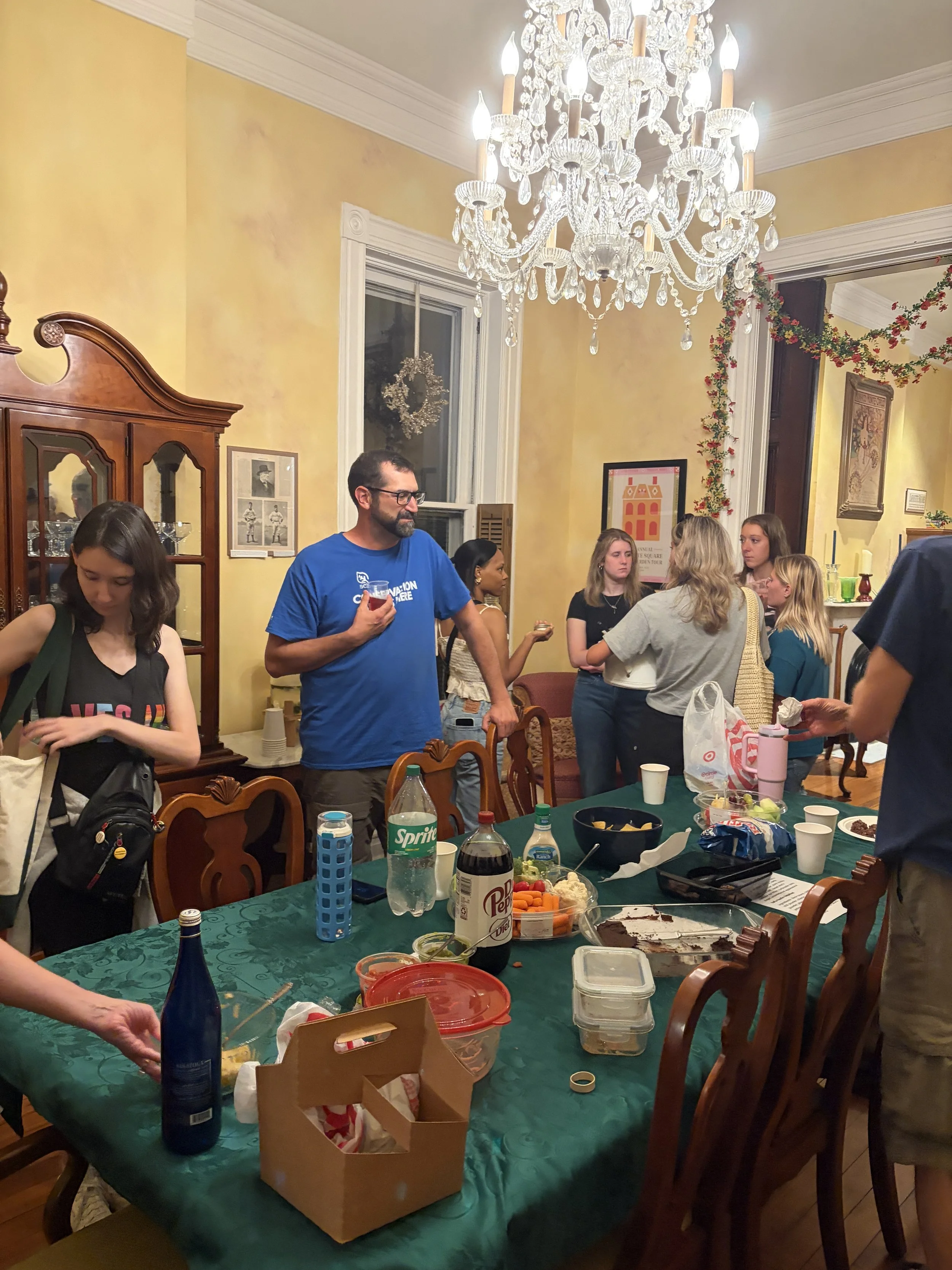 As Plant Lovers Potluck event comes to an end, guests finish chatting and pack up vegan dishes in St. Louis, Missouri.png