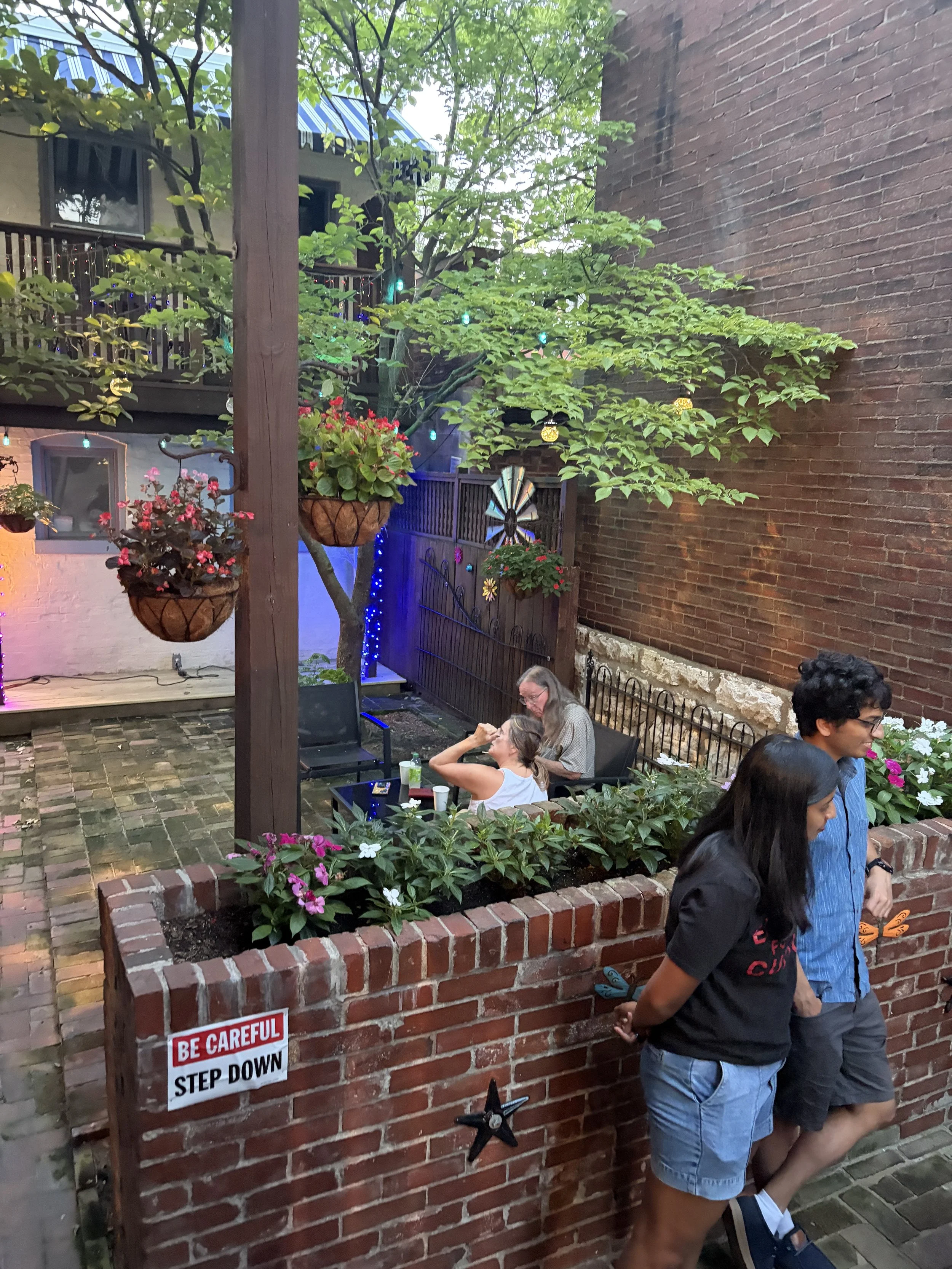 Lush exterior with attendees chatting at Plant Lovers Potluck in St. Louis, Missouri.png