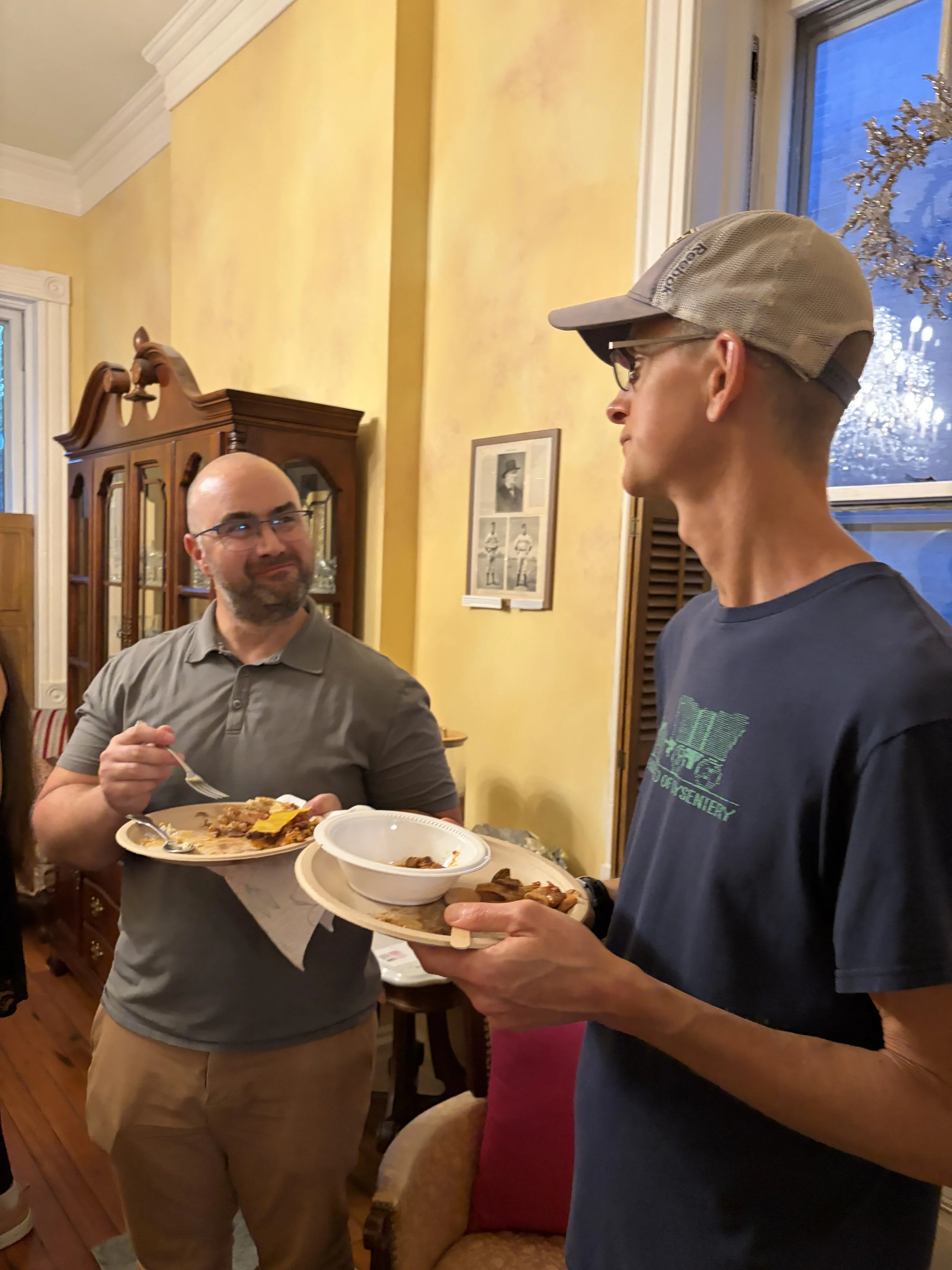 Two attendees of the Plant Lovers Potluck enjoy talking and eating scrumptious cruelty-free dishes in St. Louis, Missouri.png