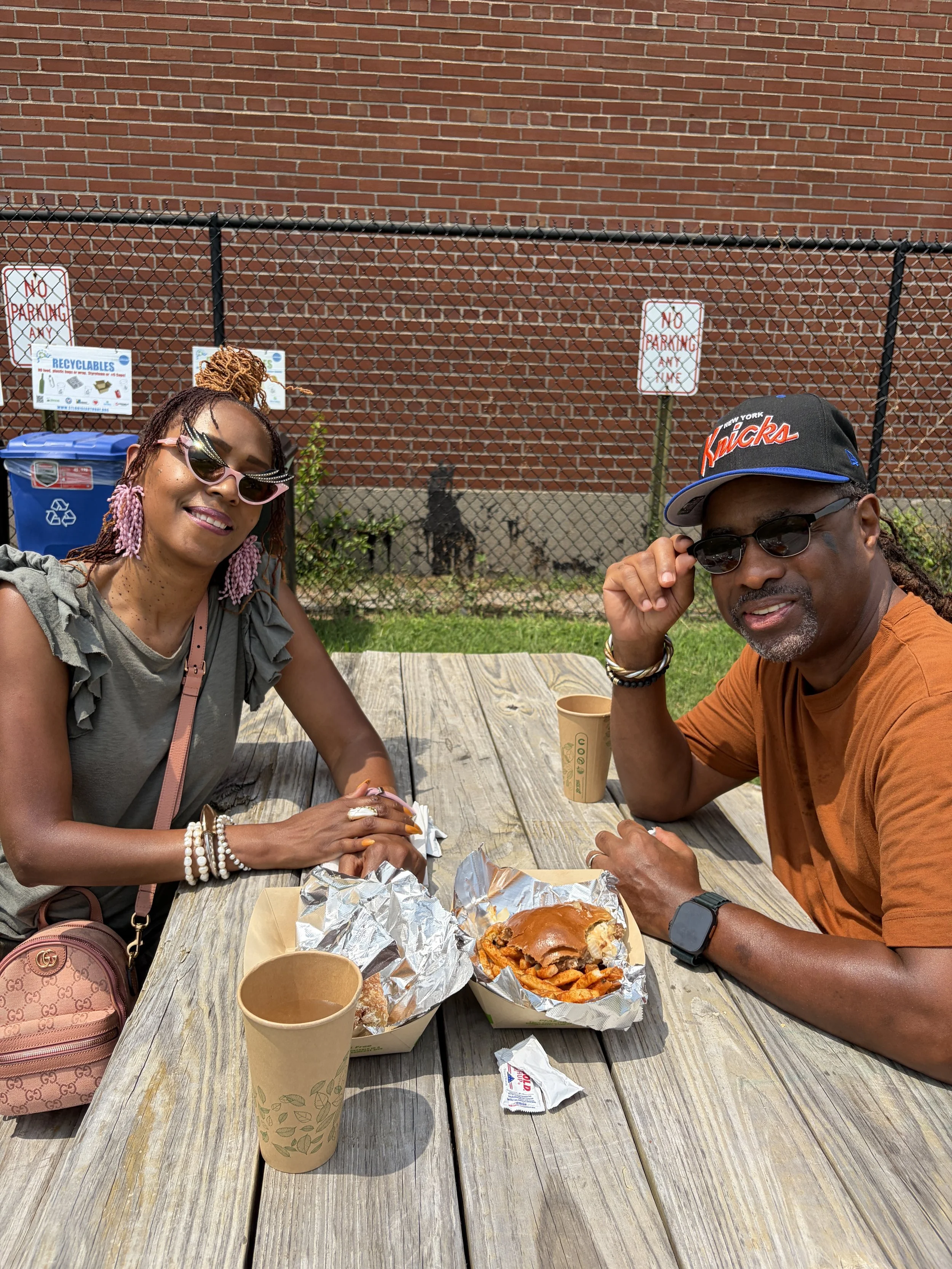 Attendees with plant-based burgers and fries eat at STL Vegan Market in St. Louis, Missouri.png