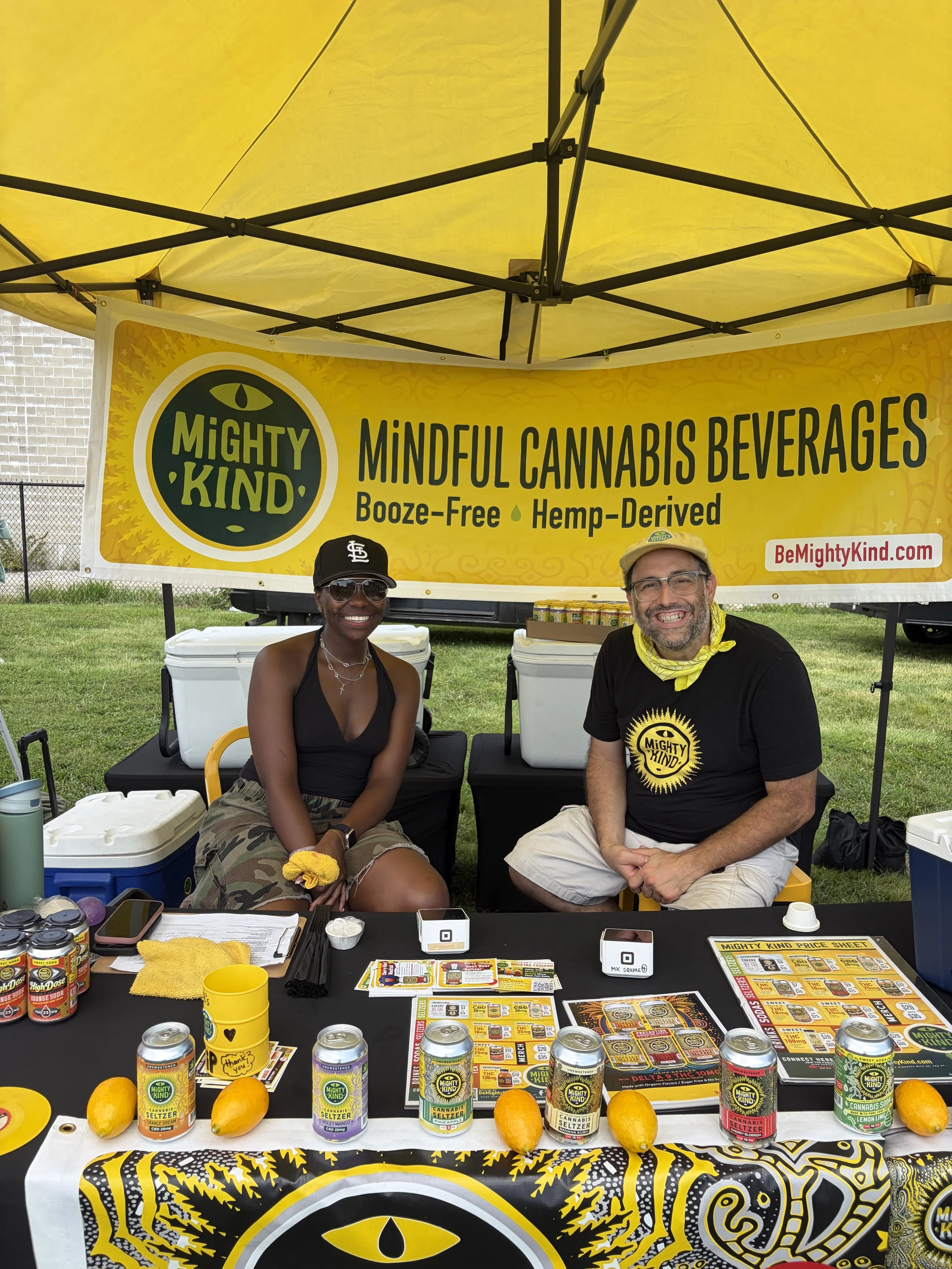 Employees of Mighty Kind, _mindful cannabis beverages_ smile for photo at STL Vegan Market in St. Louis, Missouri.png