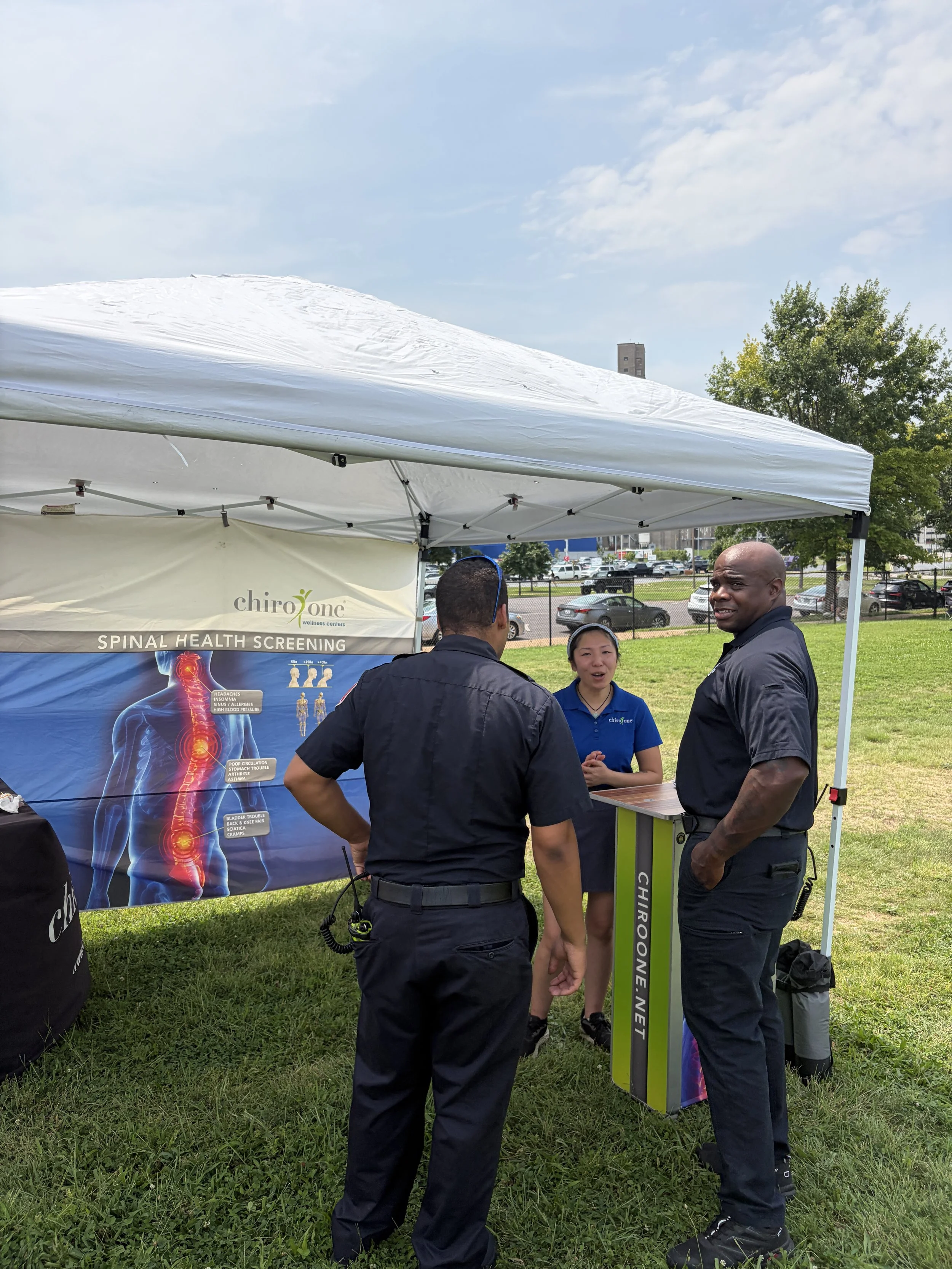 Customers chat with Chiro One, a chiropractic wellness center, at STL Vegan Market in St. Louis, Missouri.png
