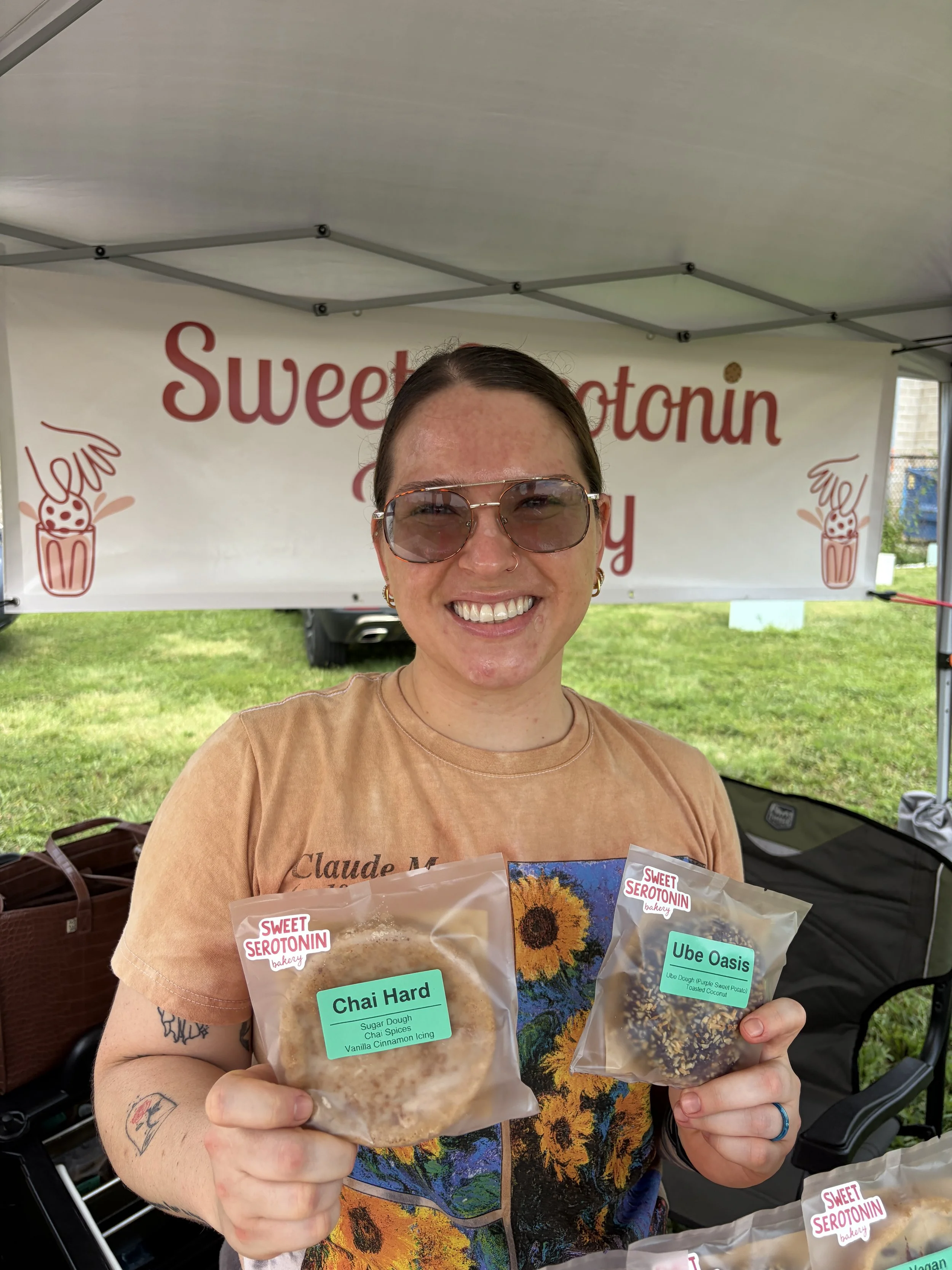 Owner of Sweet Serotonin Bakery takes a photo with scrumptious plant-based cookies at STL Vegan Market in St. Louis, Missouri.png