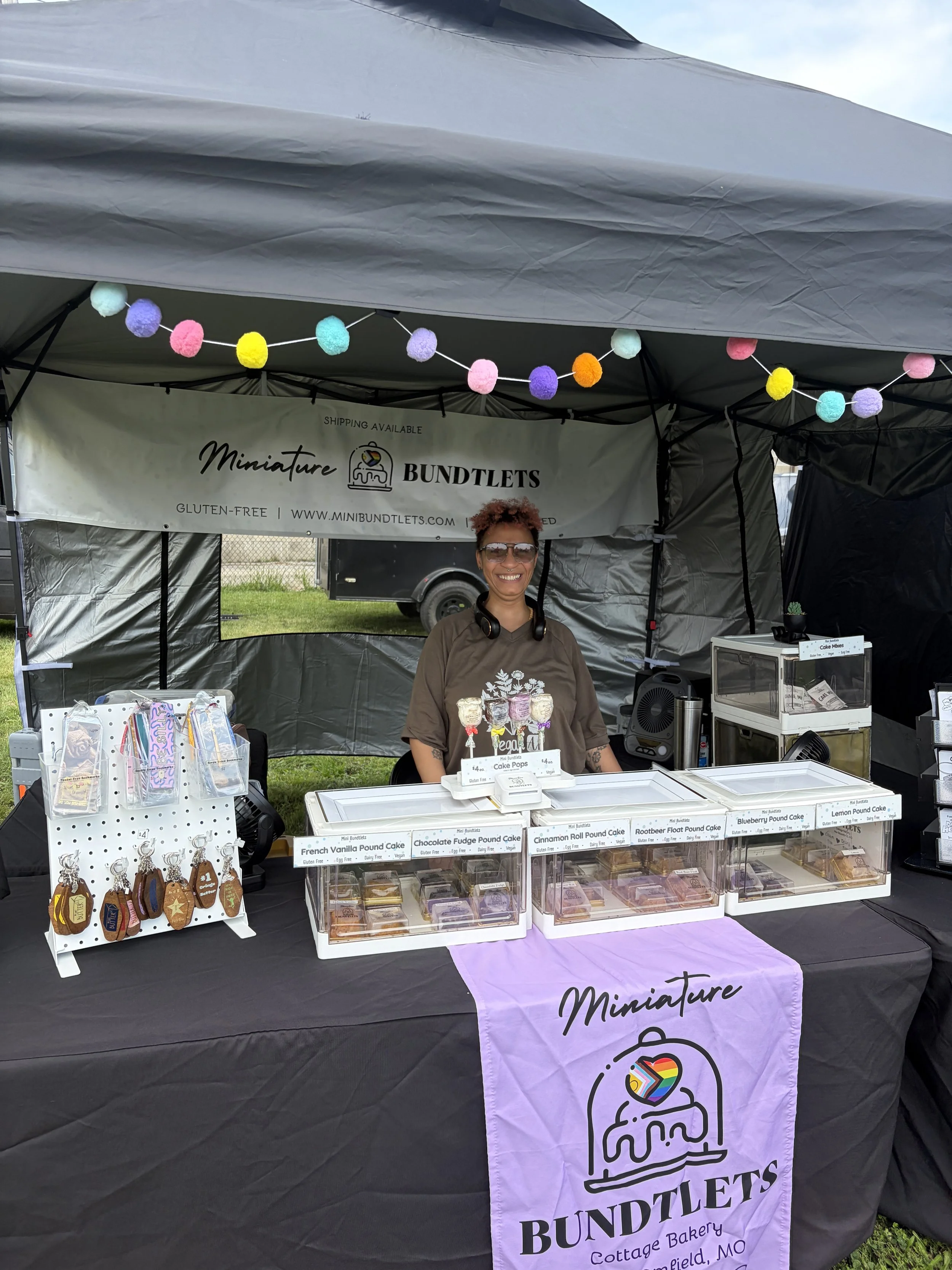 Ebony, of the 100_ vegan and gluten-free bakery Miniature Bundtlets at booth at STL Vegan Market in St. Louis, Missouri.png