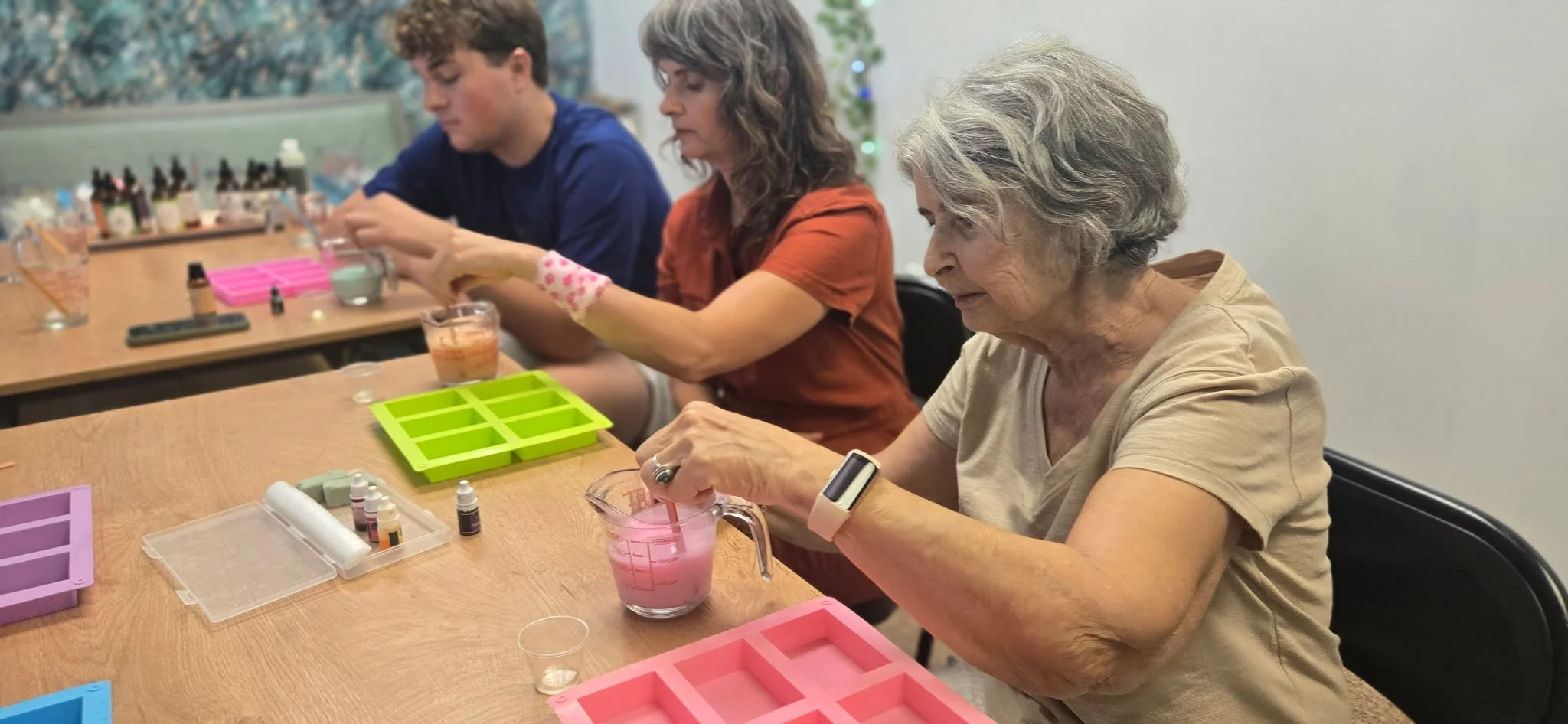 Soap-makers mix colorful melted soaps at Life and Styles Vegan Soap-Making Class in St. Louis, Missouri.png