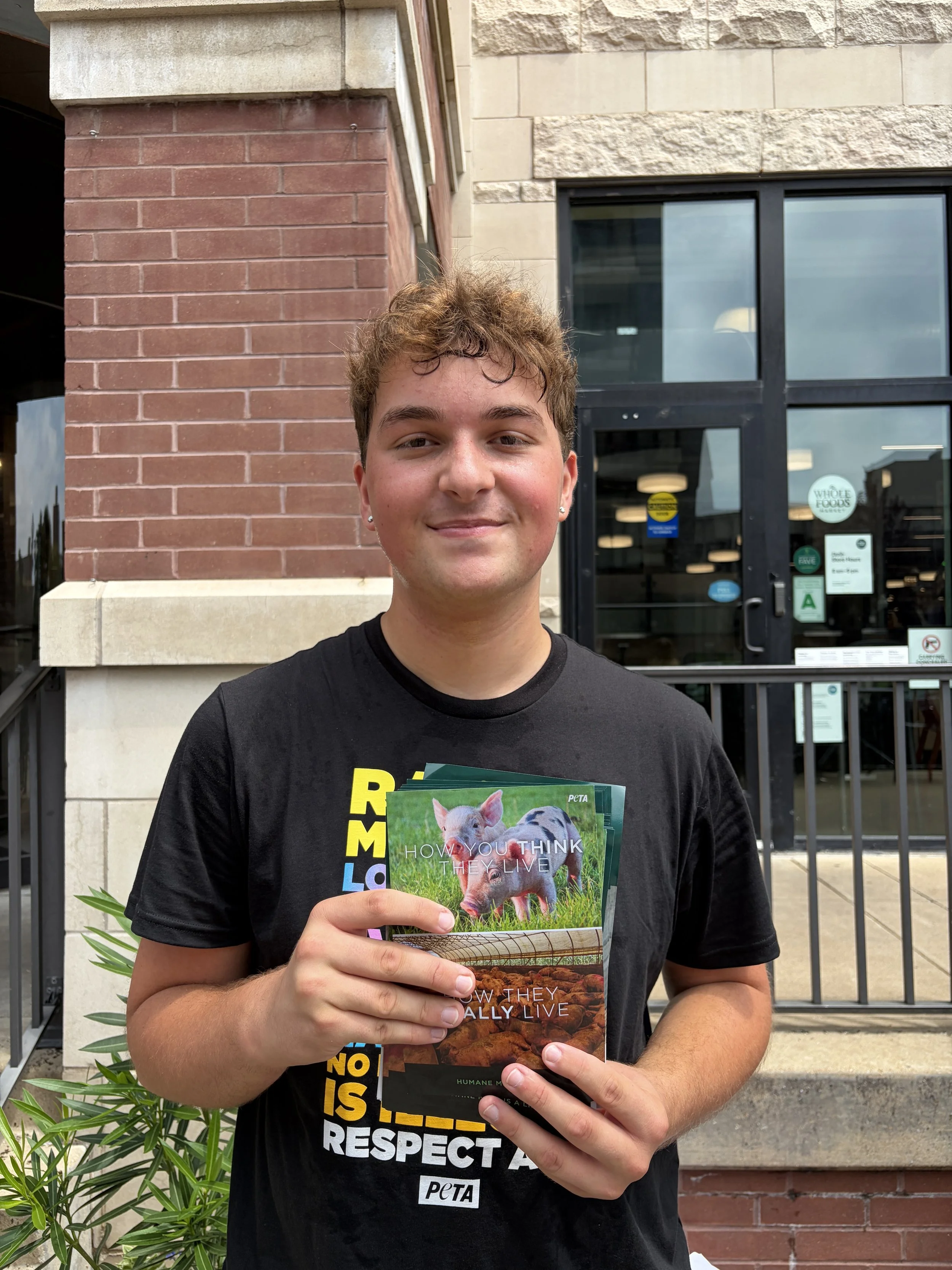 Troy holds up literature at Whole Foods Egg-spose in St. Louis, Missouri.png