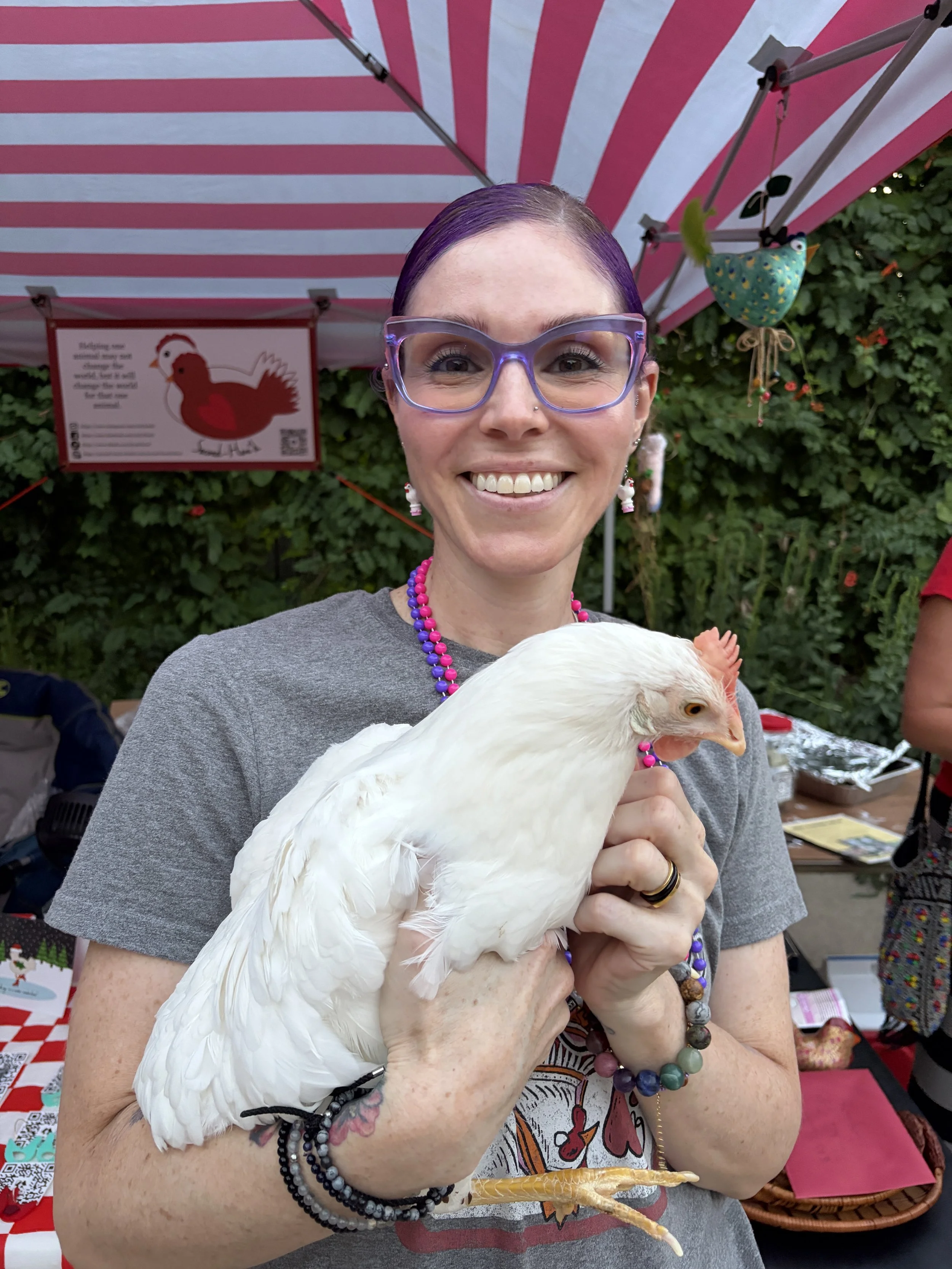 Erica, founder of Second-Hen_d, smiles with a rescue hen at Flock Party in St. Louis, Missouri.png