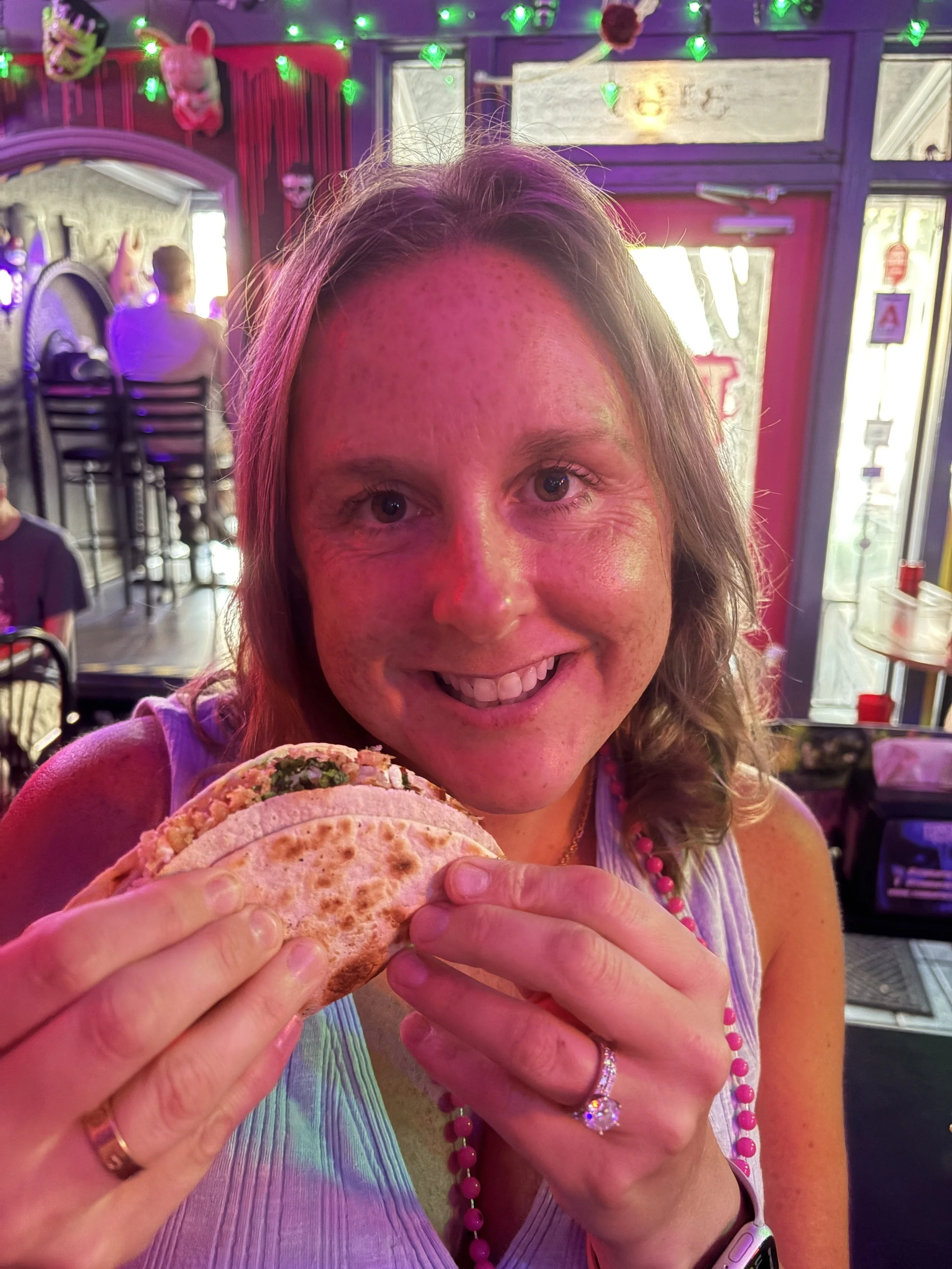 Nicole smiles with a vegan taco at Terror Tacos after visiting Second-Hen_d Flock Party in St. Louis, Missouri.png