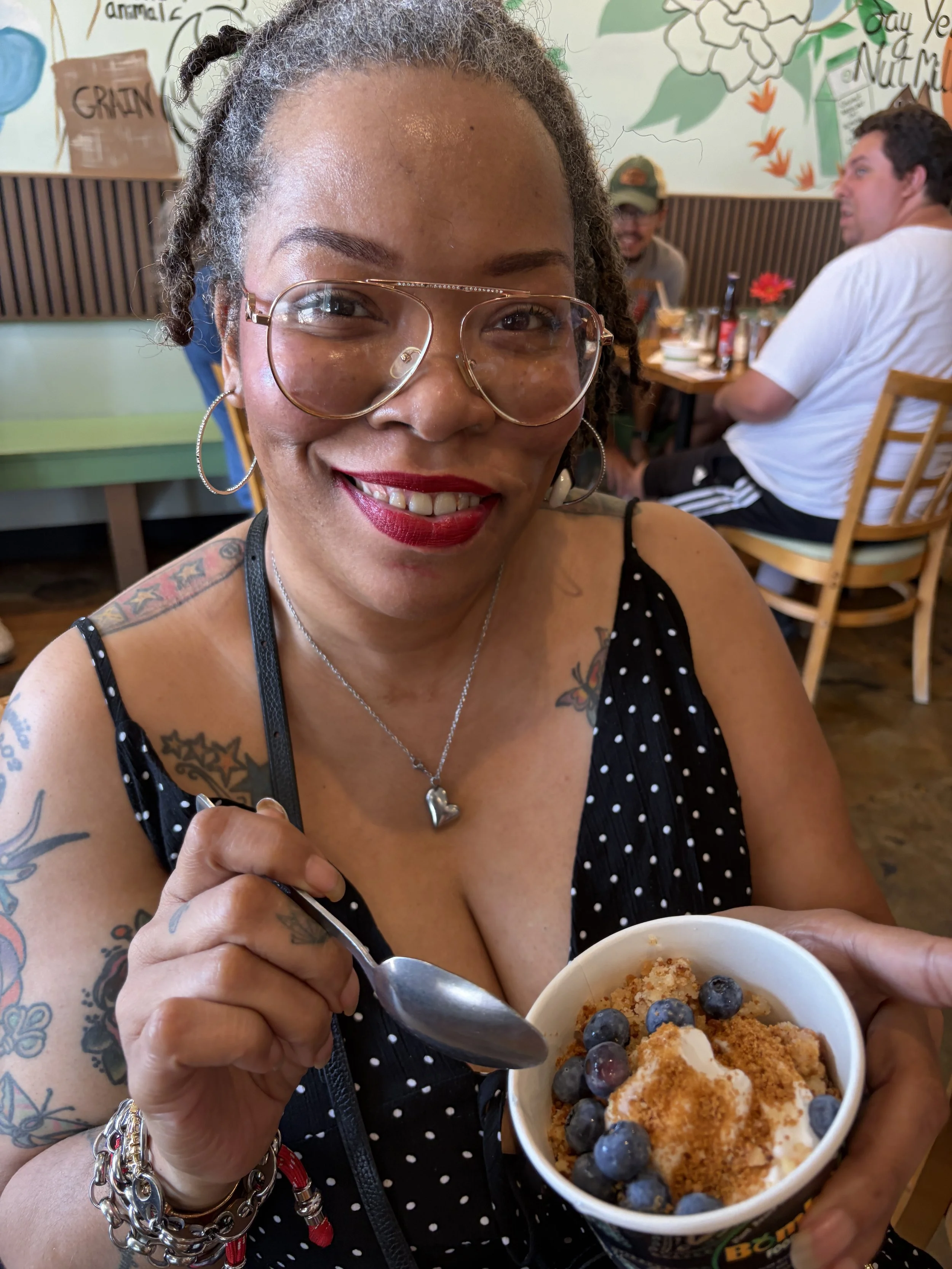 Visitor smiles with delicious dairy-free ice cream at Vegan Ice Cream Social from Bombay Food Junkies in St. Louis, Missouri.png
