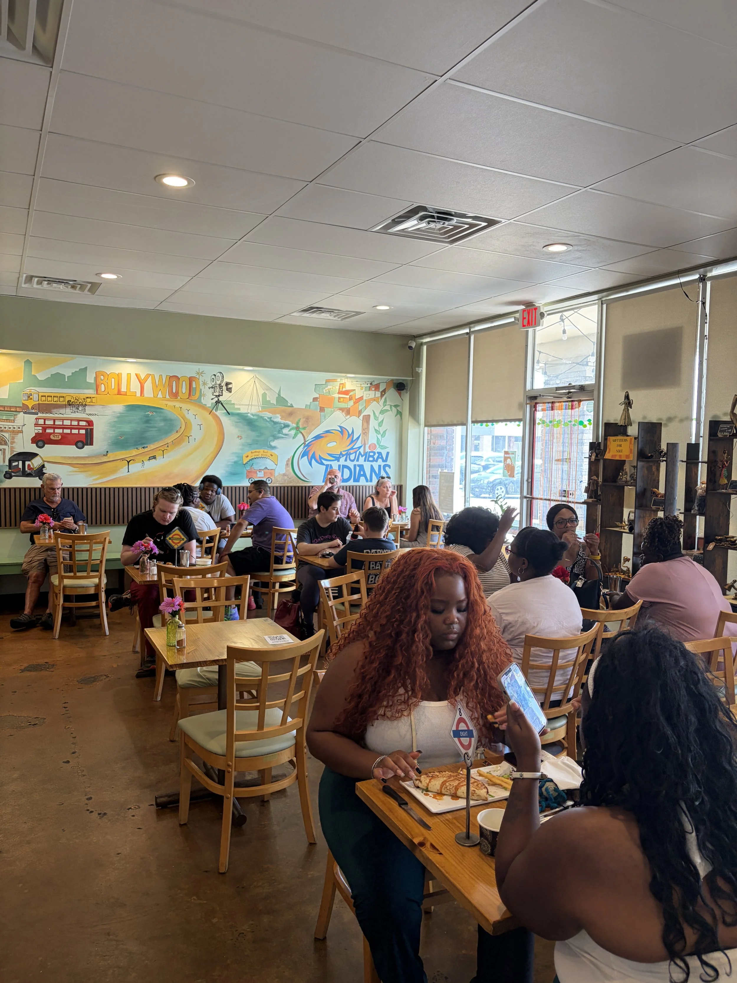 Crowd of attendees enjoy Vegan Ice Cream Social at Bombay Food Junkies in St. Louis, Missouri.png
