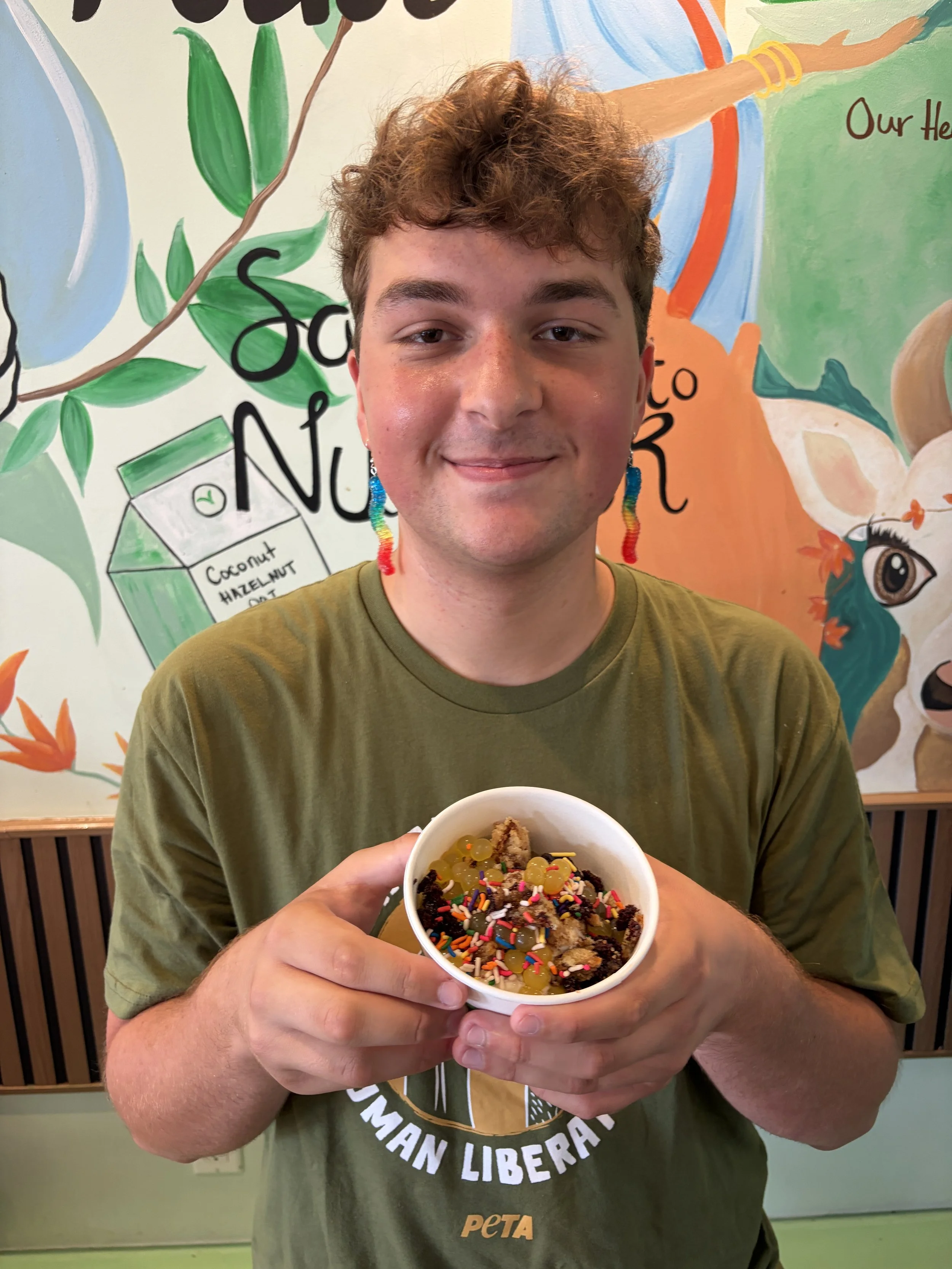 Troy smiles with plant-based soft serve at Vegan Ice Cream Social from Bombay Food Junkies in St. Louis, Missouri.png